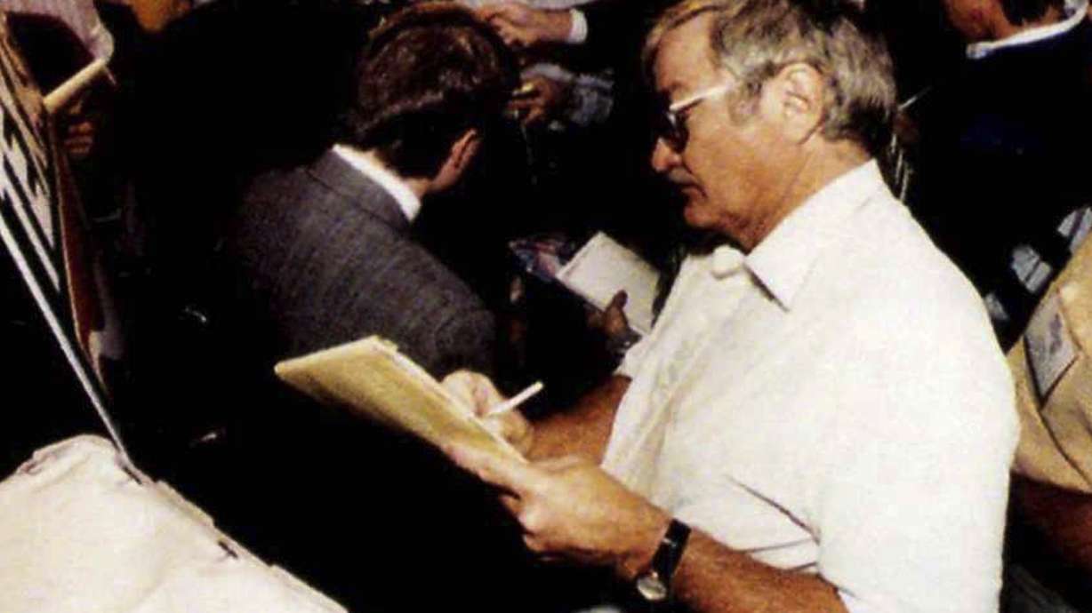 FILE - Texas sports editor, Denne Freeman listens to University of Texas Safety Stanley Richard during a news conference in Irving, Texas, just before the Cotton Bowl in 1991. Freeman, whose 32 years with the AP included covering all five Super Bowl championships won by the Dallas Cowboys and many golf majors, has died, Friday, Feb. 3, 2023 after a series of health issues. He was 86.