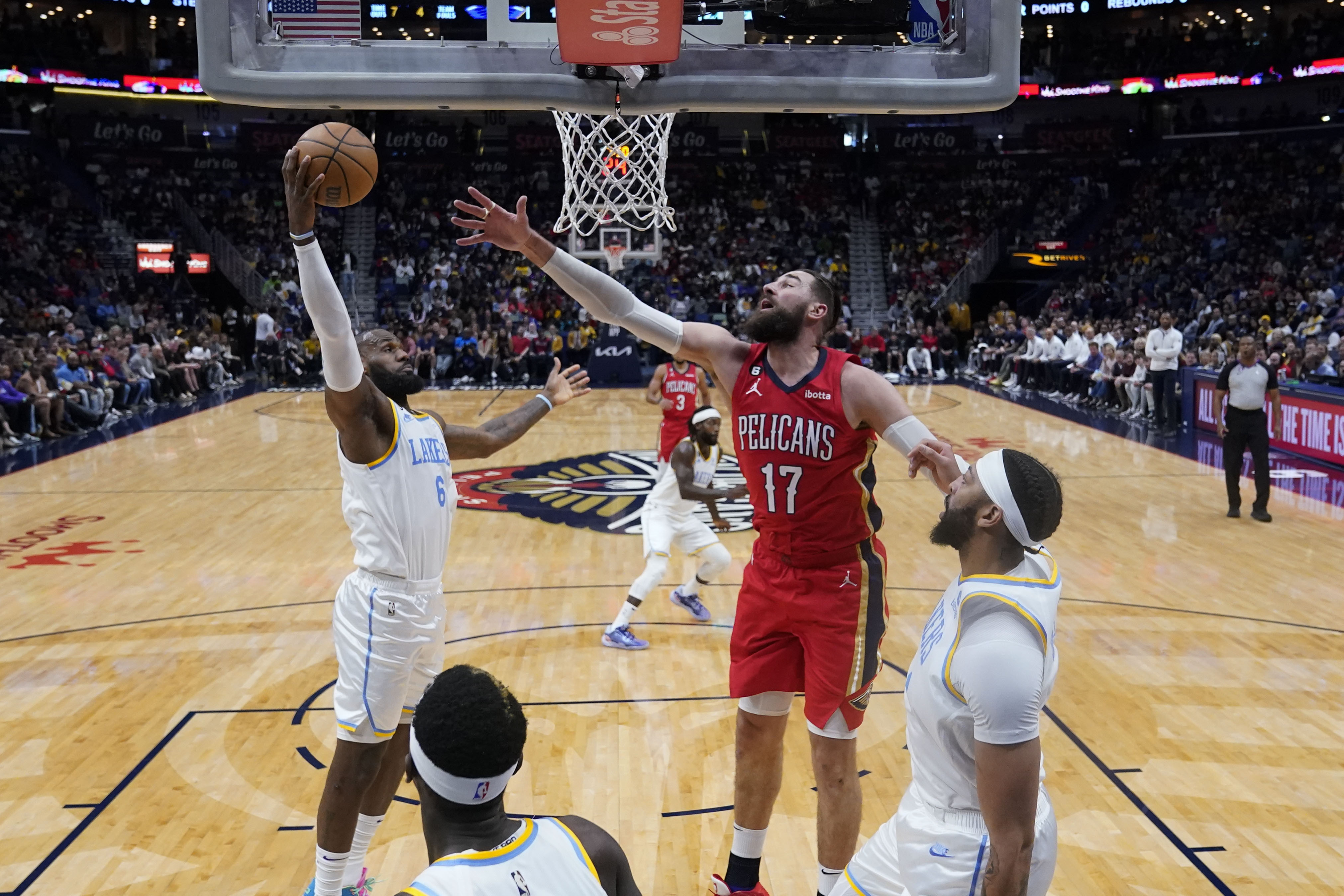 Los Angeles Lakers forward LeBron James (6) pulls down a rebound against New Orleans Pelicans center Jonas Valanciunas (17) in the first half of an NBA basketball game in New Orleans, Saturday, Feb. 4, 2023.