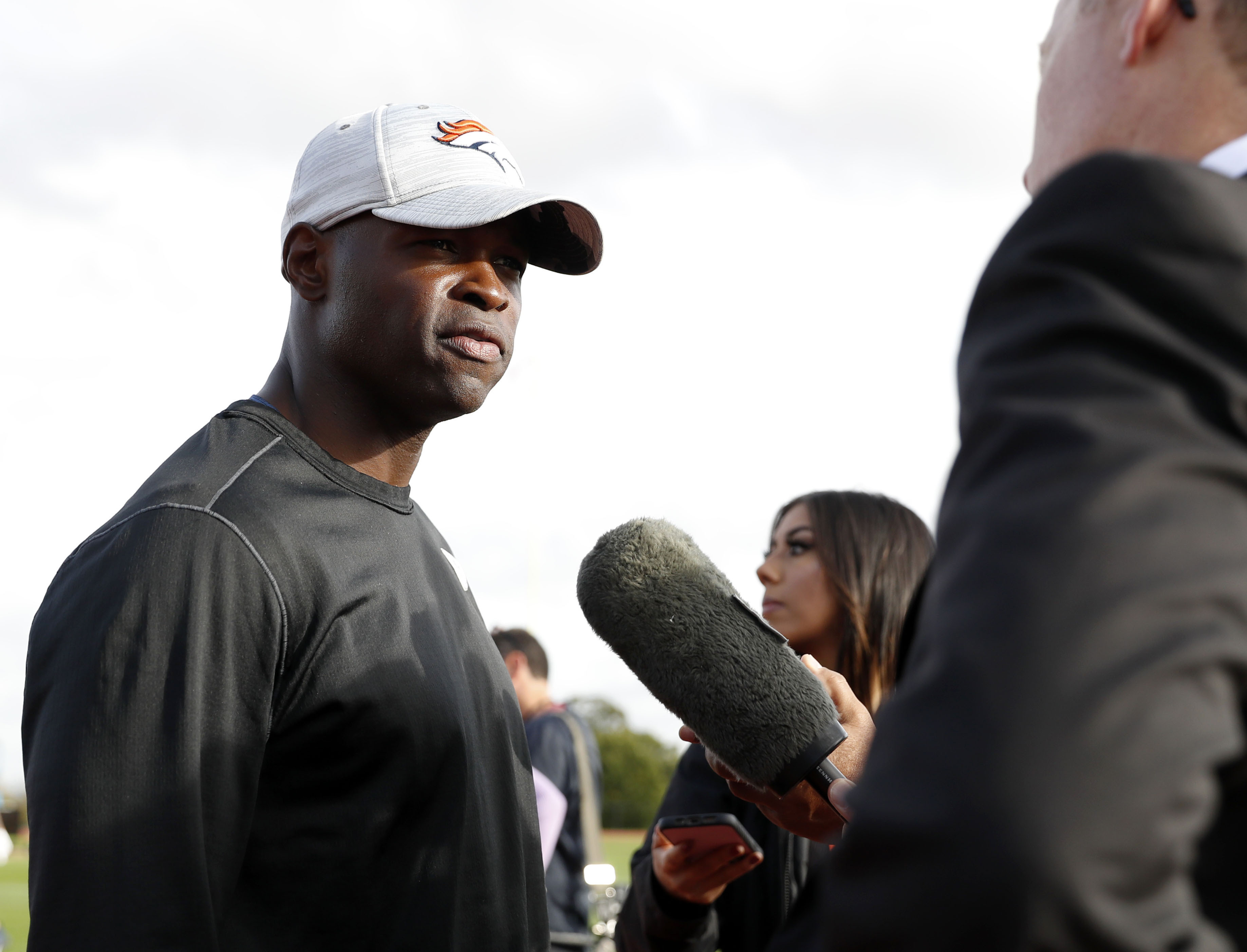 FILE - Denver Broncos defensive coordinator Ejiro Evero, left, speaks with media after a practice session in Harrow, England, Oct. 28, 2022. The Carolina Panthers have agreed to terms with Evero to be their new defensive coordinator. 