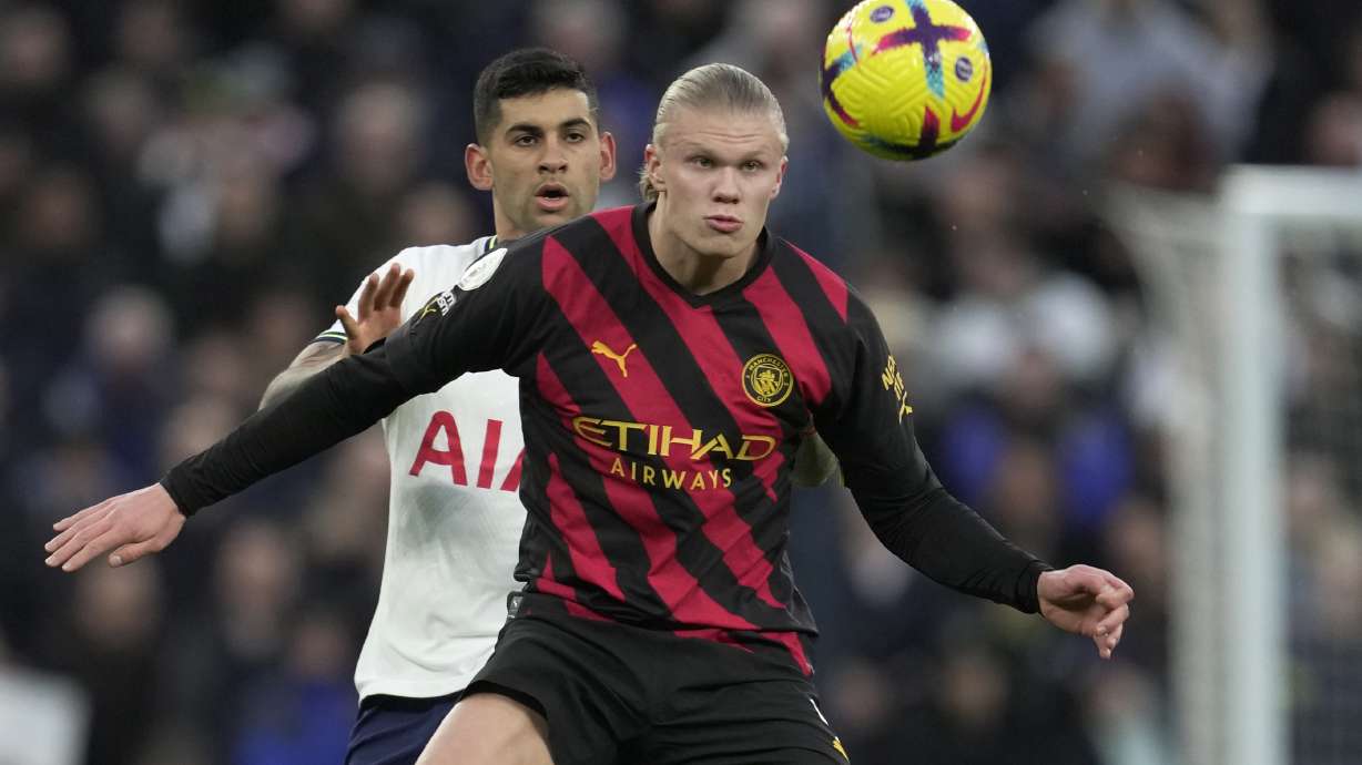 Manchester City's Erling Haaland, front, controls the ball in front of Tottenham's Cristian Romero during an English Premier League soccer match between Tottenham Hotspur v Manchester City at the Tottenham Hotspur Stadium in London, Sunday, Feb. 5, 2023.