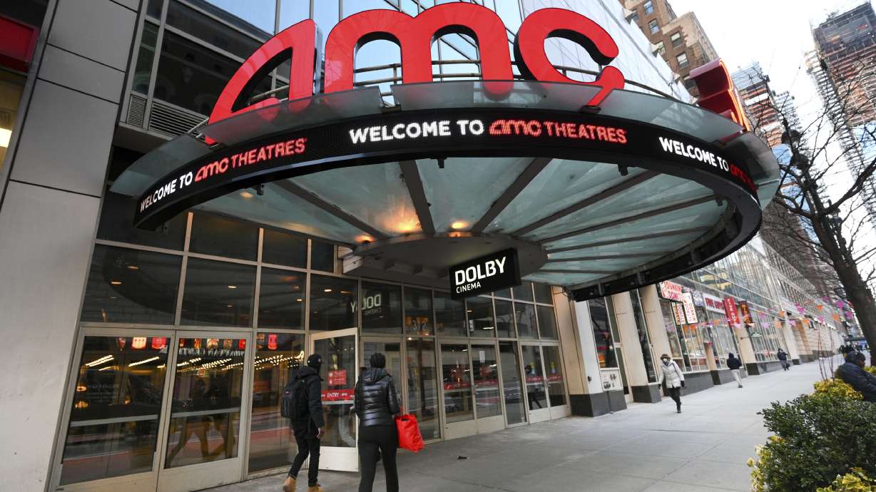People walk by the AMC 34th Street theater on March 5, 2021, in New York. AMC on Monday unveiled a new pricing scheme in which seat location determines how much the ticket costs.