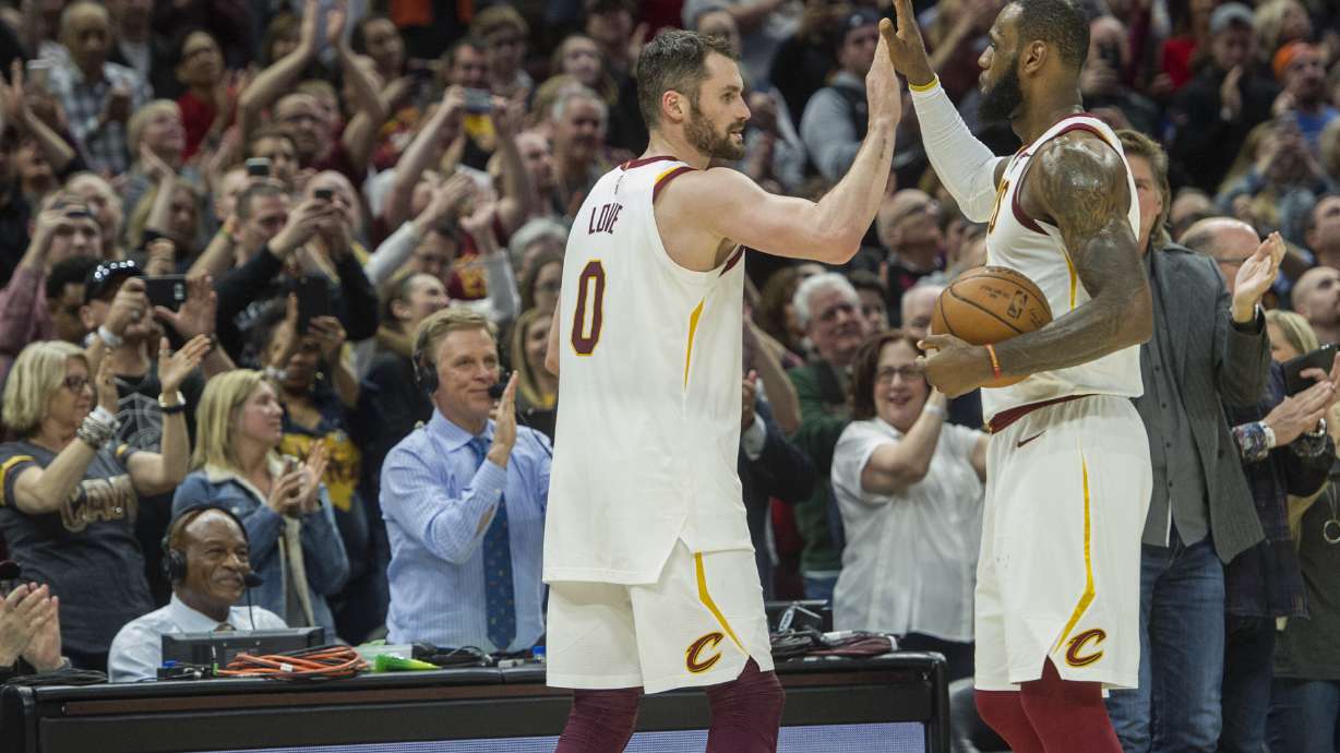 FILE - Cleveland Cavaliers' LeBron James, right, is congratulated by Kevin Love, after Jame's 867th consecutive game scoring in double figures during the first half of an NBA basketball game against the New Orleans Pelicans in Cleveland, Friday, March 30, 2018. James surpassed the old mark of 866 held by Michael Jordan. Cavaliers forward Love, in an essay for The Associated Press, reflected on his years as James' teammate. James is about to pass Kareem Abdul-Jabbar for the NBA career scoring record.