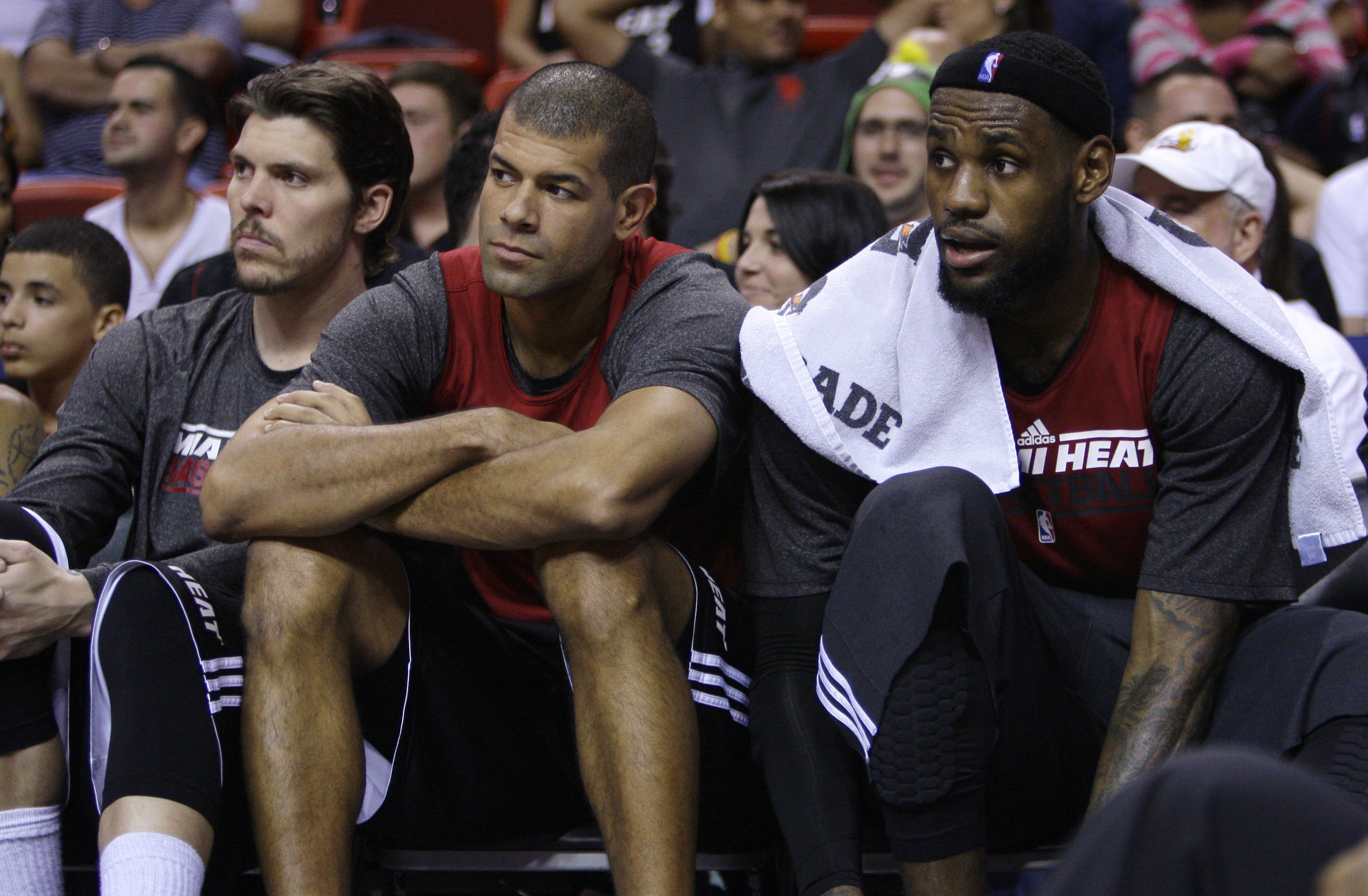 FILE - Miami Heat's Mike Miller, left, Shane Battier, center, and LeBron James, right, watch from the bench during a Miami Heat NBA basketball scrimmage on Thursday, Dec. 15, 2011, in Miami. Former Heat forward Battier, in an essay for The Associated Press, says he would sometimes marvel at the things James did when they were teammates. James is about to pass Kareem Abdul-Jabbar for the NBA career scoring record.