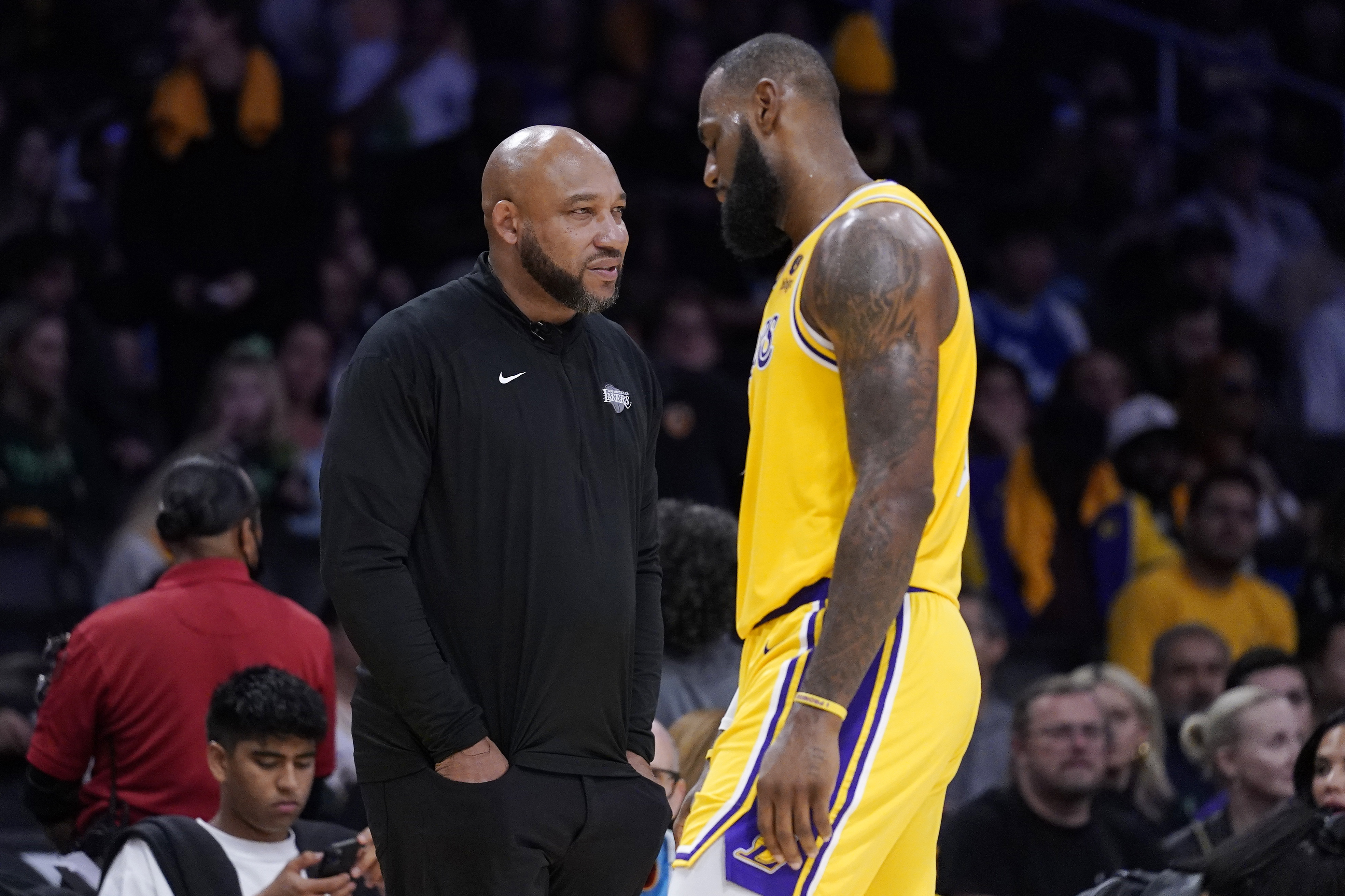 FILE - Los Angeles Lakers forward LeBron James, right, walks back to the bench as head coach Darvin Ham stands on the court during the second half of an NBA basketball game against the Los Angeles Clippers, Thursday, Oct. 20, 2022, in Los Angeles. Lakers coach Ham, in an essay for The Associated Press, says James' work ethic is beyond compare. James is about to pass Kareem Abdul-Jabbar for the NBA career scoring record.