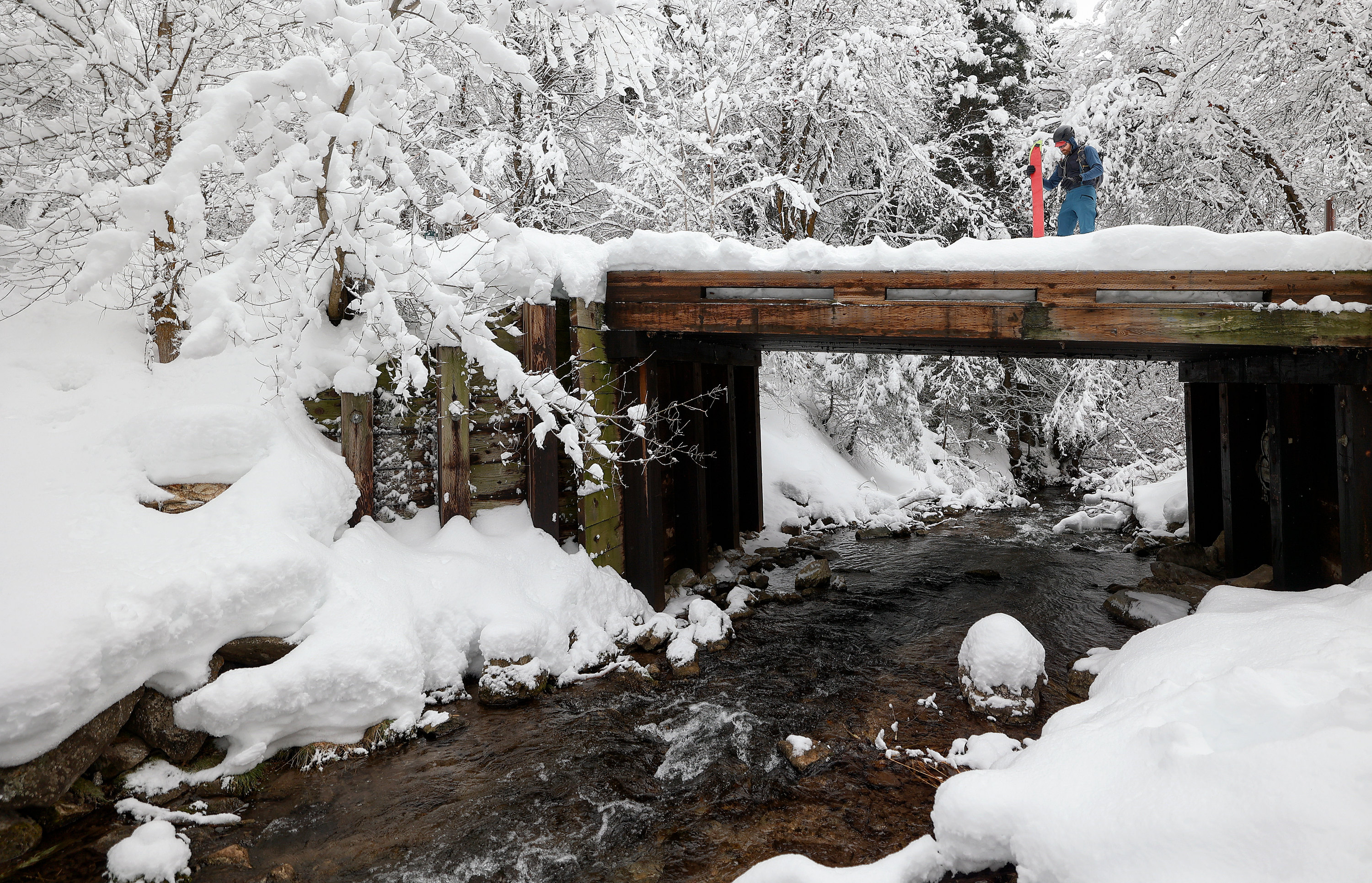 James Donigan prepares to split-board as Mill Creek flows below him in Millcreek Canyon on Jan. 3. Utah's statewide snowpack surpassed the seasonal normal Monday, according to Natural Resources Conservation Service data.