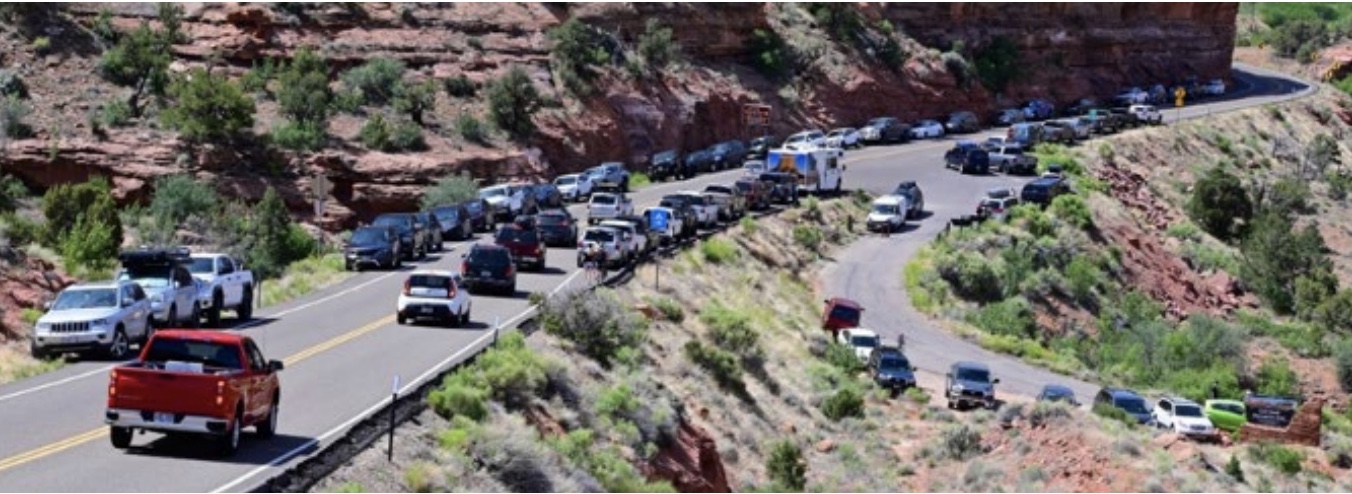 This photo shows vehicles parked or traveling through state Route 12 at the entrance to Calf Creek Recreation Area in 2020.