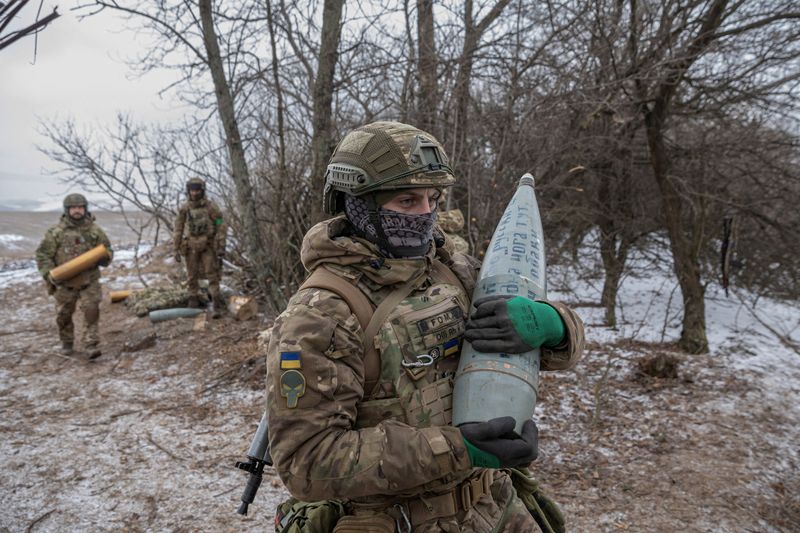 Members of the 3rd Separate Assault Brigade of the Armed Forces of Ukraine prepare to fire a howitzer near Bahmut, Ukraine, Monday. Ukrainian President Volodymyr Zelenskyy embarked on a European tour on Wednesday to drum up aid.