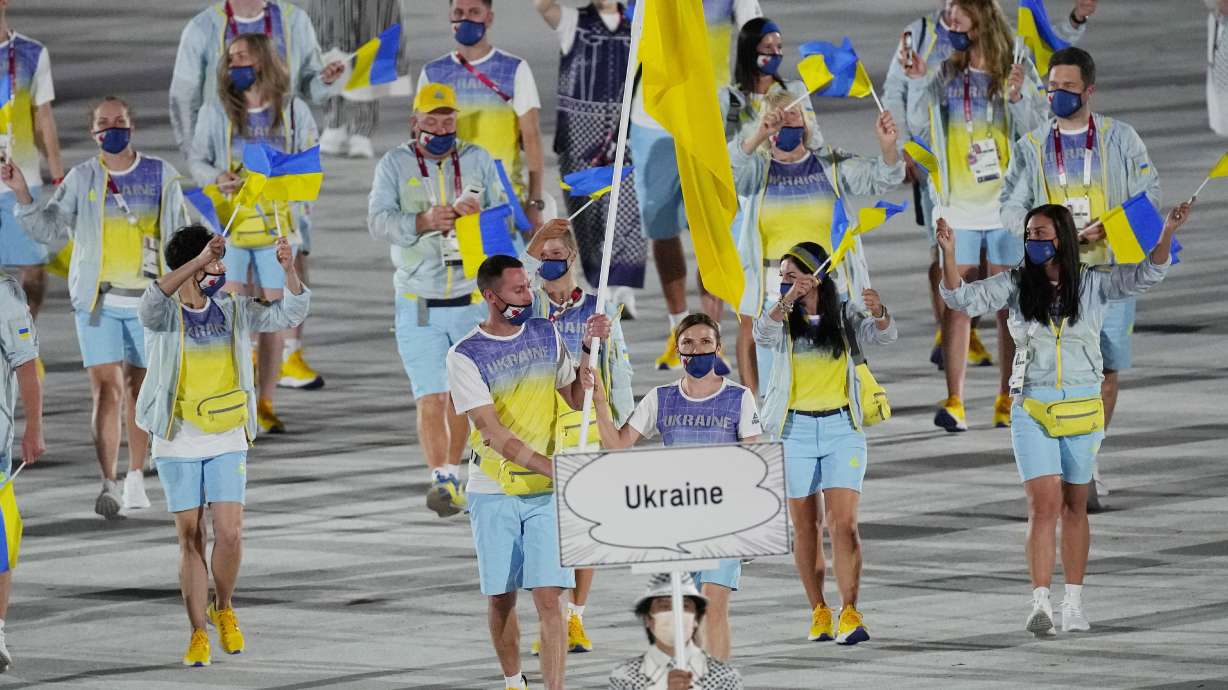 Olena Kostevych and Bogdan Nikishin, of Ukraine, carry their country’s flag during the opening ceremony in the Olympic Stadium at the 2020 Summer Olympics, on July 23, 2021, in Tokyo. Ukraine has stepped up efforts to lobby international sports leaders against Russian participation in next year’s Paris Olympics.