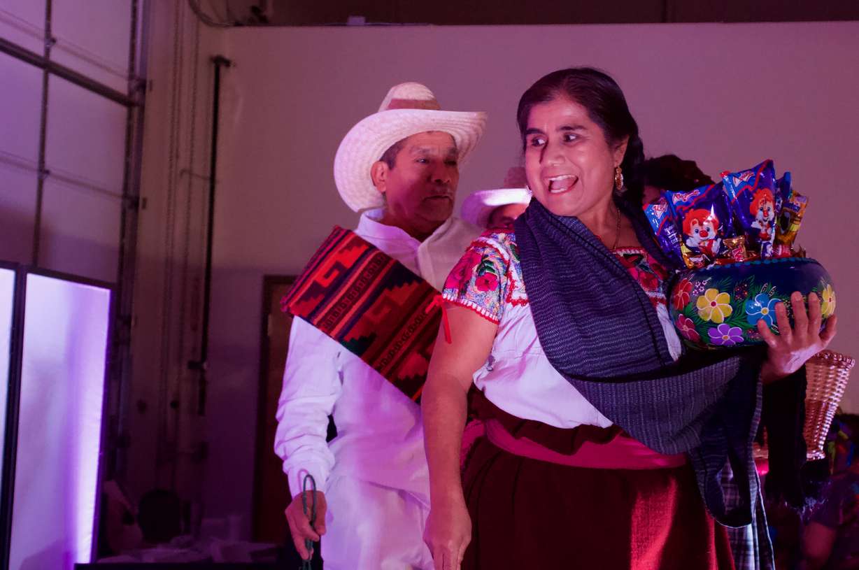 Calixta Chávez, right, and husband Jeronimo Bazan-Alavez prepare to walk down the runway in clothing from their village Teotitlan del Valle.
