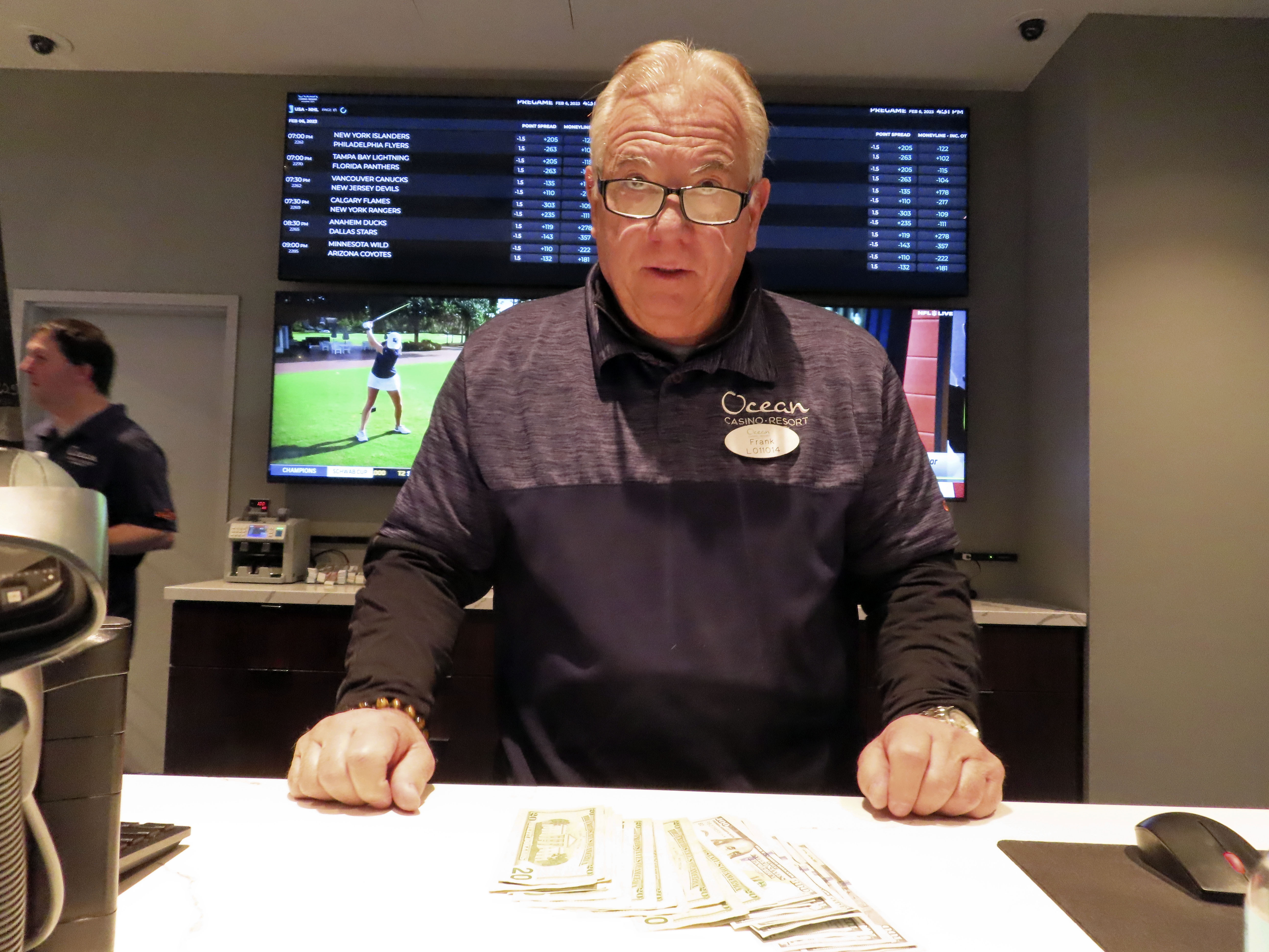 Frank Caltagirone, a sports book employee at the Ocean Casino Resort in Atlantic City, N.J., counts money from his drawer Monday, Feb. 6, 2023. On Feb. 7, 2023, the gambling industry's national trade group, the American Gaming Association, predicted that over 50 million American adults will bet a total of $16 billion on this year's Super Bowl, including legal bets with sports books, illegal ones with bookies, and casual bets among friends or relatives.