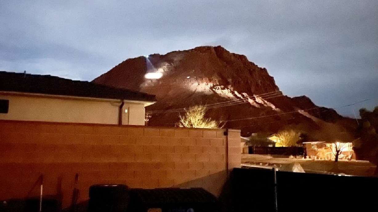 Rescue teams work to rescue a lost hiker on Red Mountain Sunday night, Ivins, Utah, Sunday.