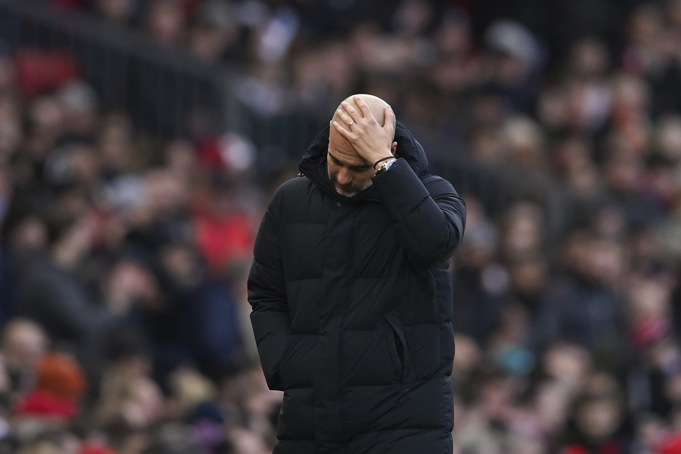 Manchester City's head coach Pep Guardiola reacts during the English Premier League soccer match between Manchester United and Manchester City at Old Trafford in Manchester, England, Saturday, Jan. 14, 2023.