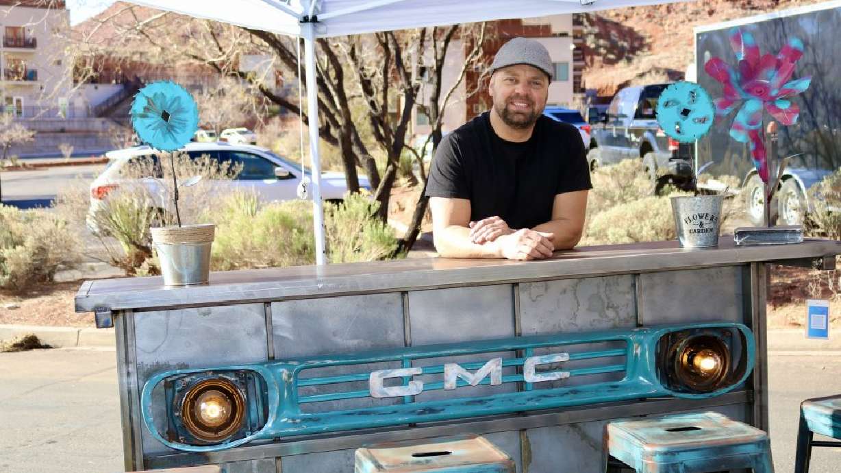 Aaron Mathews stands next to his custom furniture design at the Tuacahn Saturday Market in Ivins, Washington County, Feb. 4. He is giving old cars a second chance by turning them into home decor and seating.