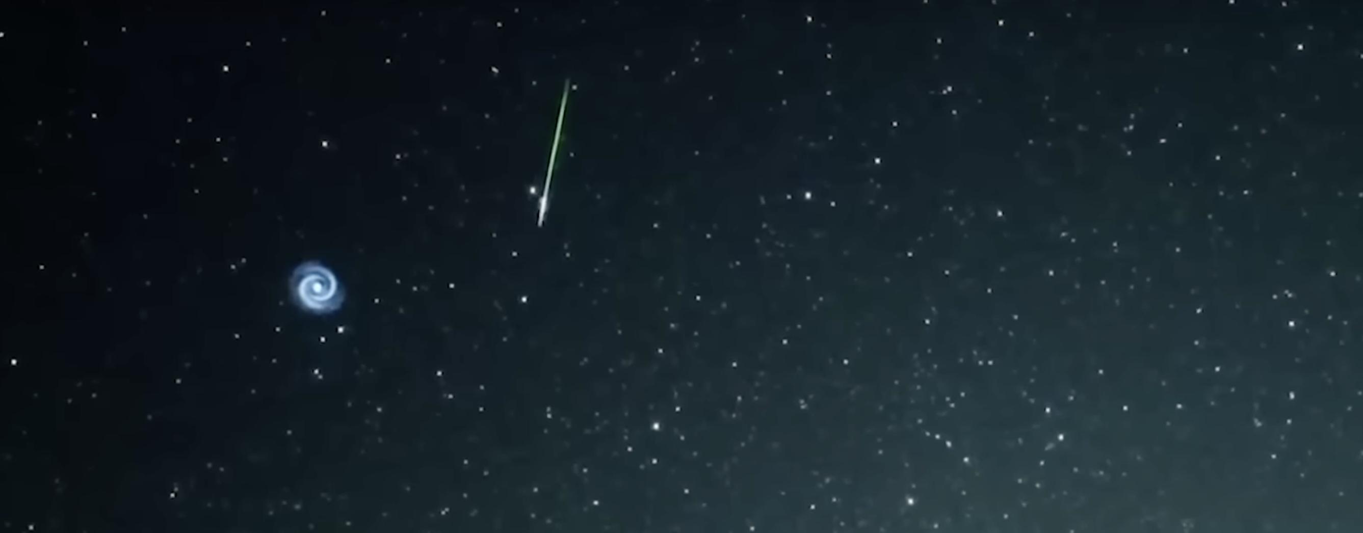 A blue spiral is visible next to a shooting star in the sky above Mauna Kea, Hawaii, on Jan. 18.