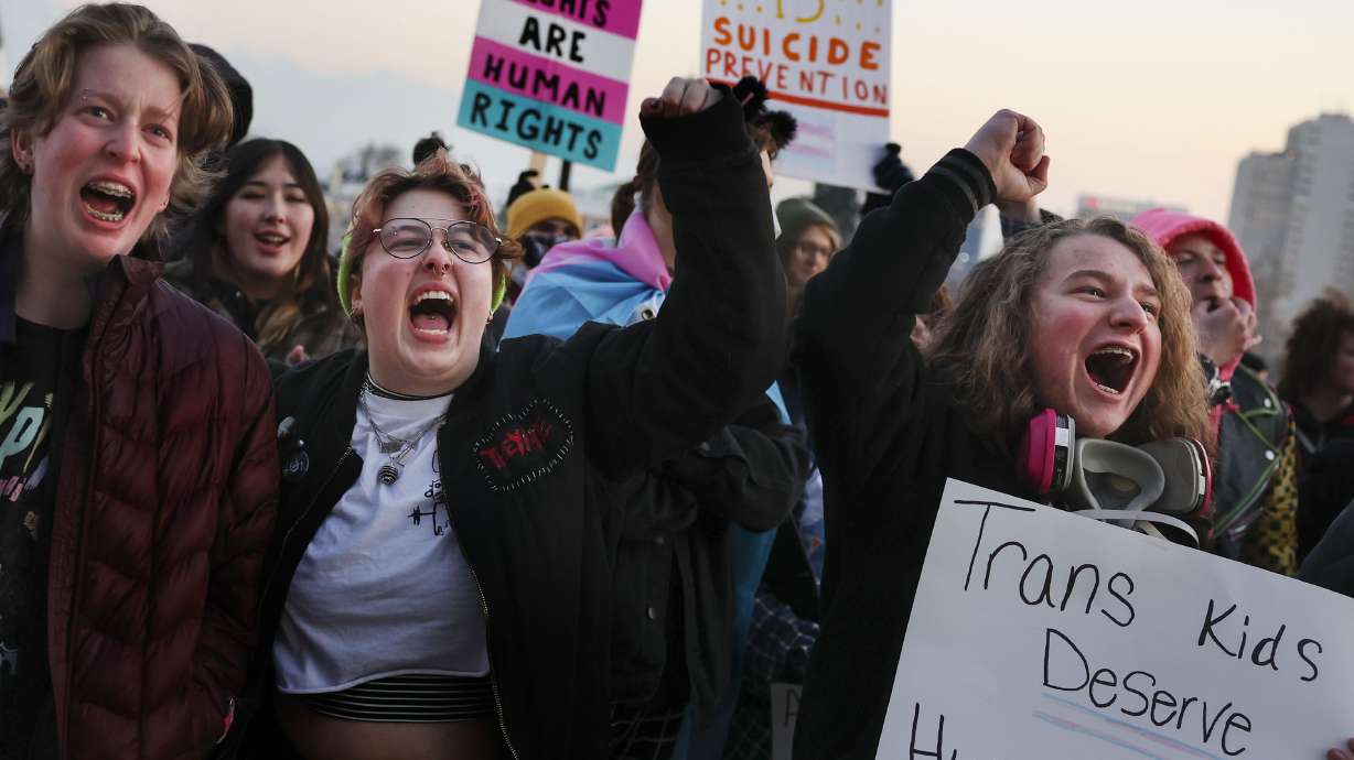 Elliot Ellis, left, Eamon Christiansen and Aiden Muhlestein rally in support of transgender youth at the Capitol in Salt Lake City on Feb. 1. A majority of Utahns agree with a bill to ban transgender surgeries for Utah children and teens — but a fair amount don't, reflecting just how divisive the issue has been in the Beehive State.