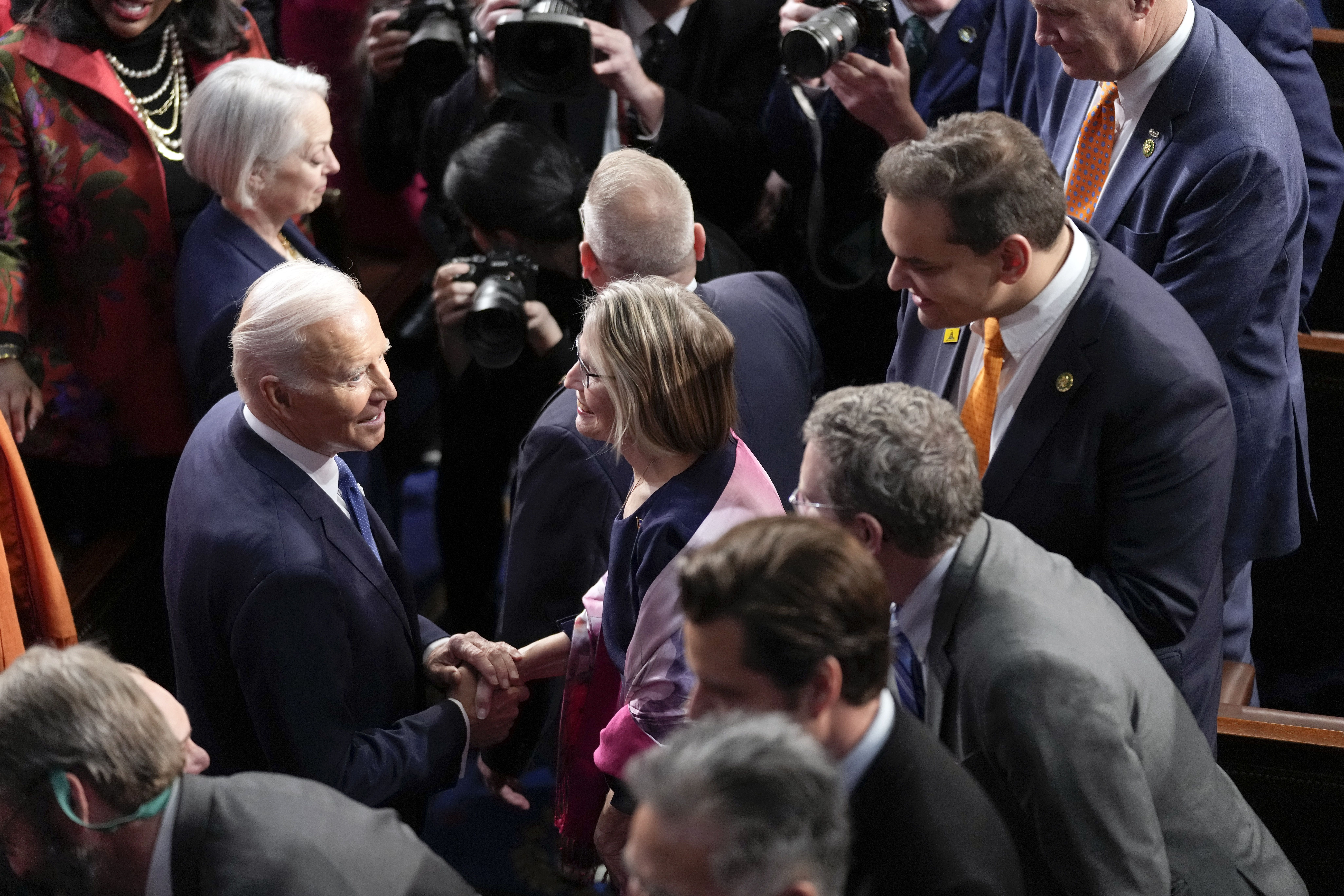 President Joe Biden arrives to deliver the State of the Union address to a joint session of Congress at the U.S. Capitol, Tuesday in Washington. Rep. George Santos, R-N.Y., is at right.