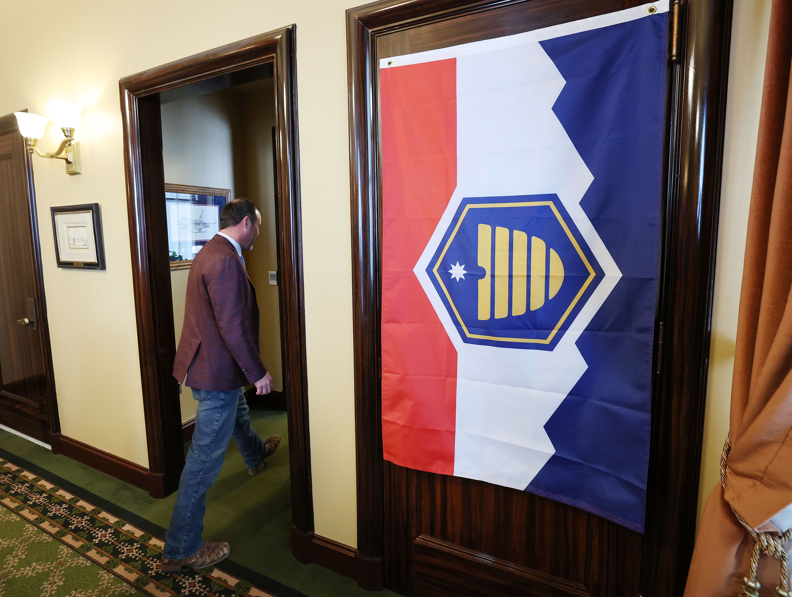 House Majority Whip Mike Schultz, R-Hooper, walks out of the House speaker’s door past the new Utah flag at the Capitol in Salt Lake City on Jan. 27. Many Utahns have embraced the new flag. Opponents, however, have been working overtime to reverse this change.