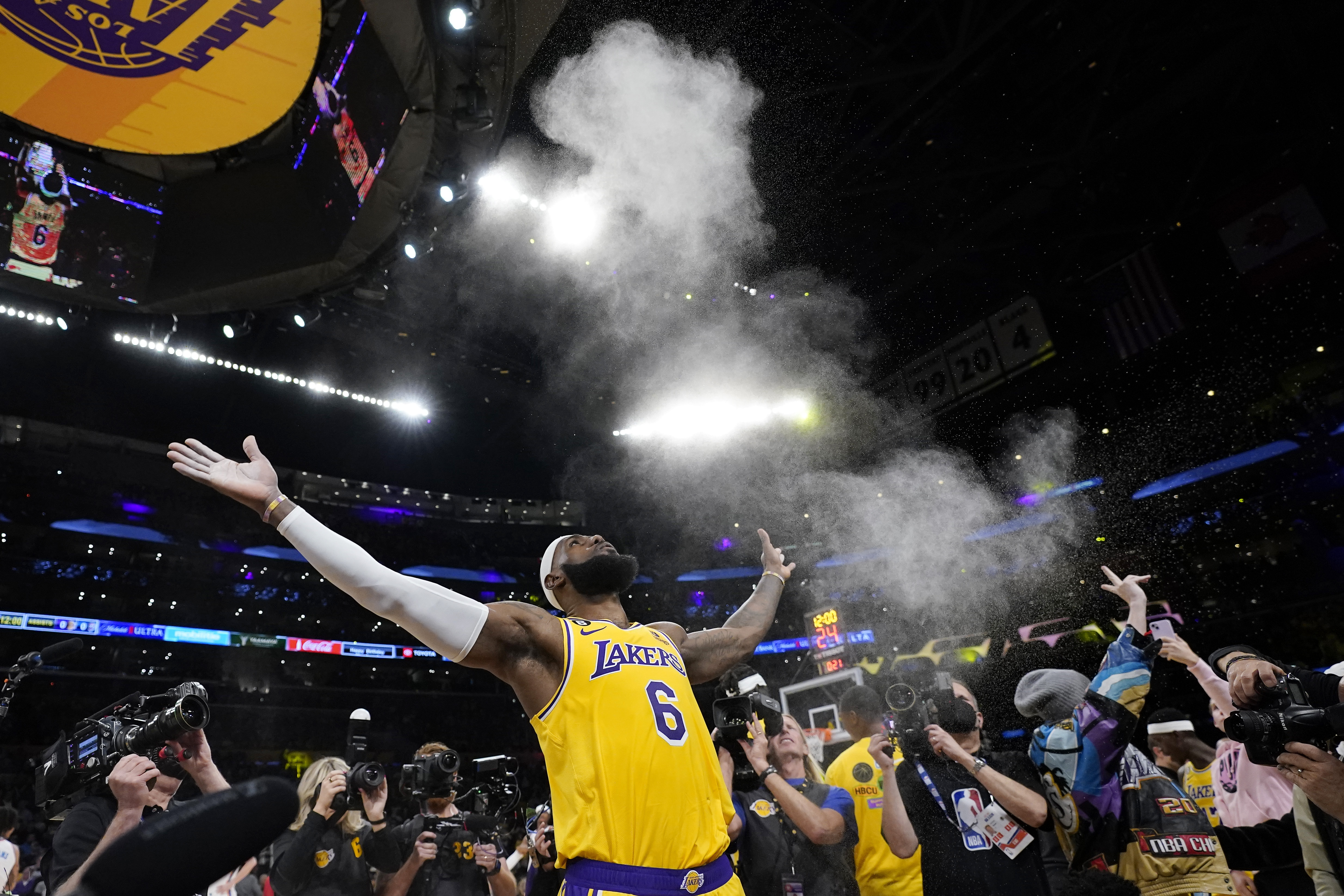 Los Angeles Lakers forward LeBron James tosses powder in the air prior to the team's NBA basketball game against the Oklahoma City Thunder on Tuesday, Feb. 7, 2023, in Los Angeles.