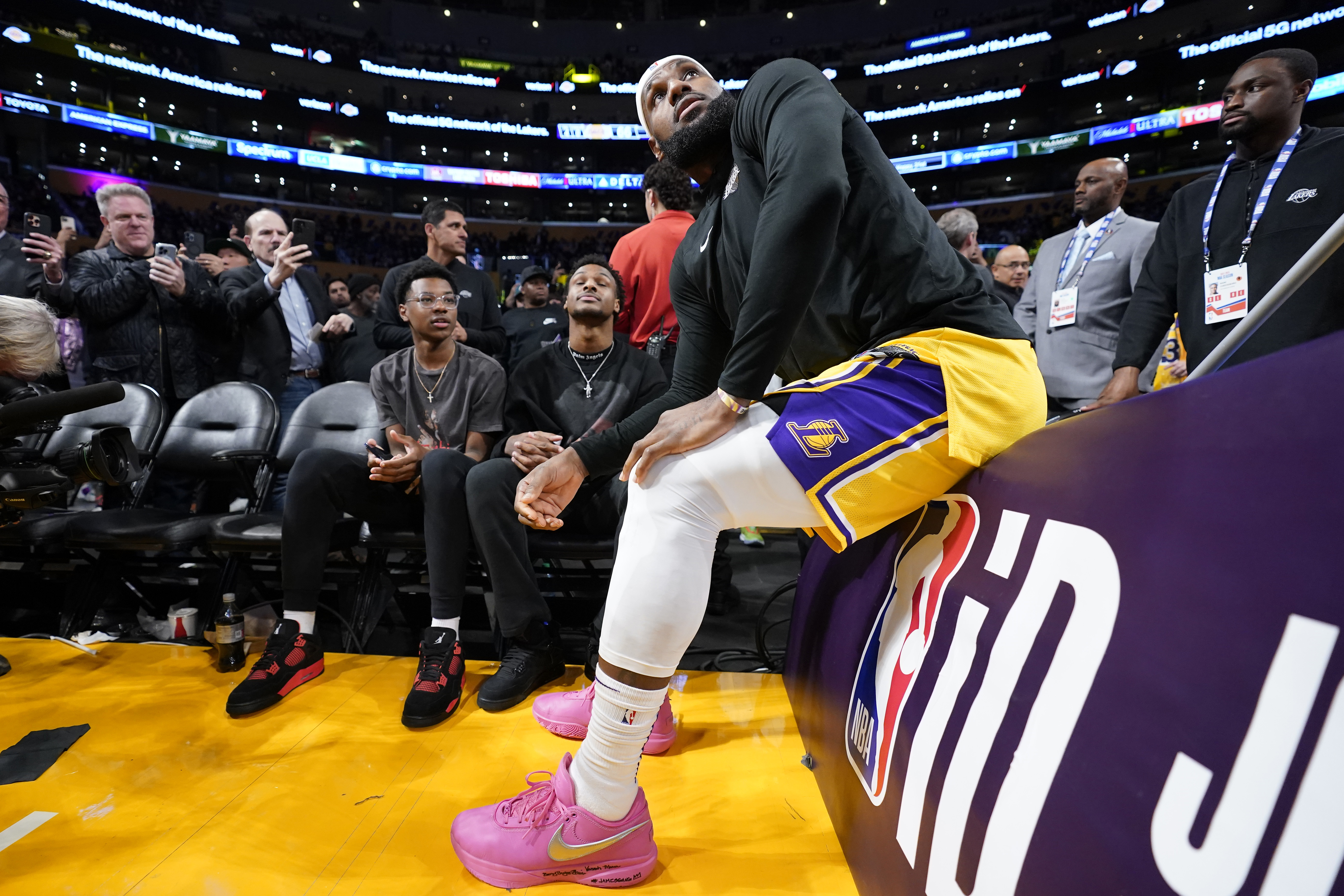Los Angeles Lakers forward LeBron James talks with his kids prior to the second half of an NBA basketball game against the Oklahoma City Thunder Tuesday, Feb. 7, 2023, in Los Angeles. 