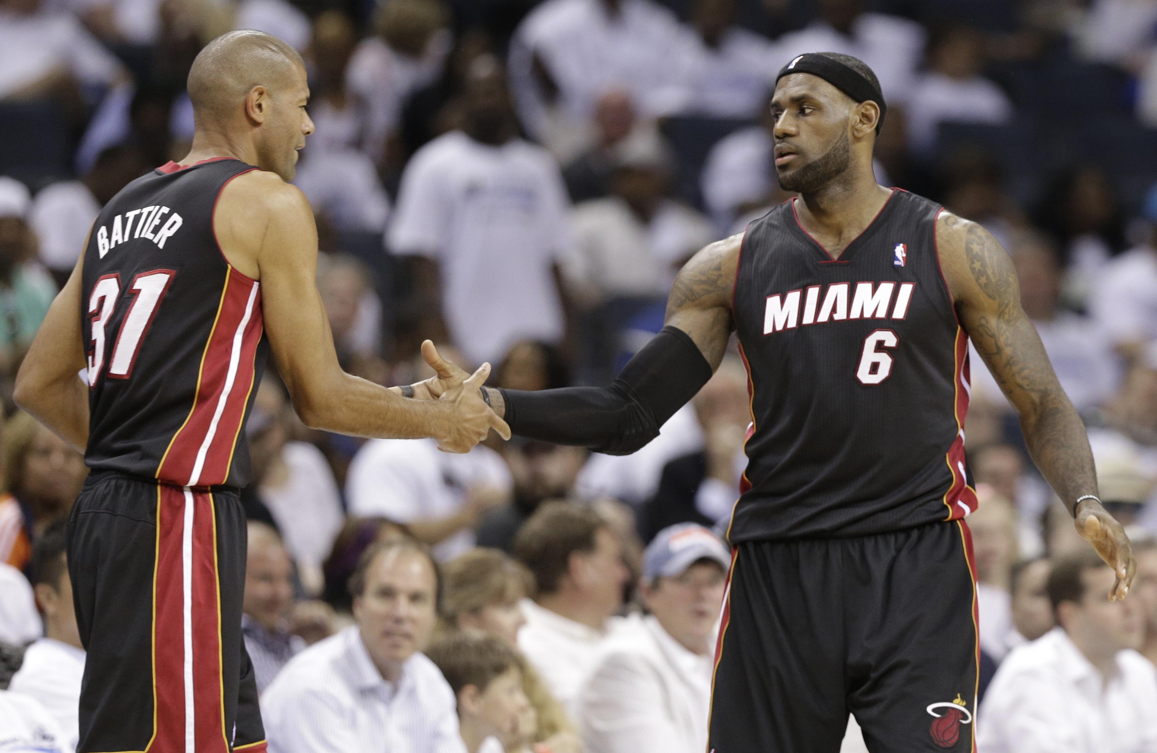FILE - Miami Heat's LeBron James (6) is congratulated by Shane Battier (31) late during the second half in Game 3 of an opening-round NBA basketball playoff series against the Charlotte Bobcats in Charlotte, N.C., Saturday, April 26, 2014. Former Heat forward Battier, in an essay for The Associated Press, says he would sometimes marvel at the things James did when they were teammates. James is about to pass Kareem Abdul-Jabbar for the NBA career scoring record. 