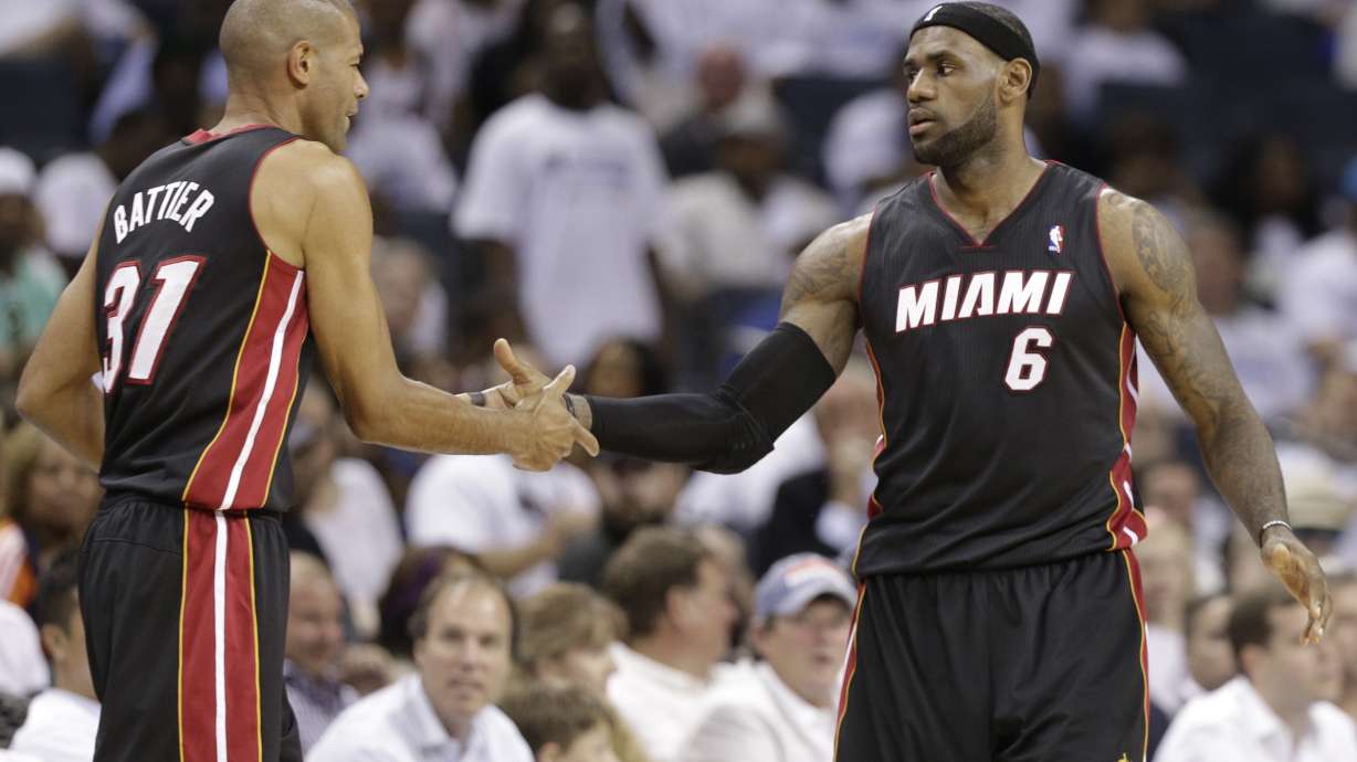 FILE - Miami Heat's LeBron James (6) is congratulated by Shane Battier (31) late during the second half in Game 3 of an opening-round NBA basketball playoff series against the Charlotte Bobcats in Charlotte, N.C., Saturday, April 26, 2014. Former Heat forward Battier, in an essay for The Associated Press, says he would sometimes marvel at the things James did when they were teammates. James is about to pass Kareem Abdul-Jabbar for the NBA career scoring record.