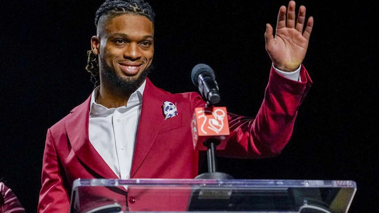 Buffalo Bills' Damar Hamlin waves after being introduced as the winner of the Alan Page Community Award during a news conference ahead of the Super Bowl 57 NFL football game, Wednesday, Feb. 8, 2023, in Phoenix. The Kansas City Chiefs will play the Philadelphia Eagles on Sunday.