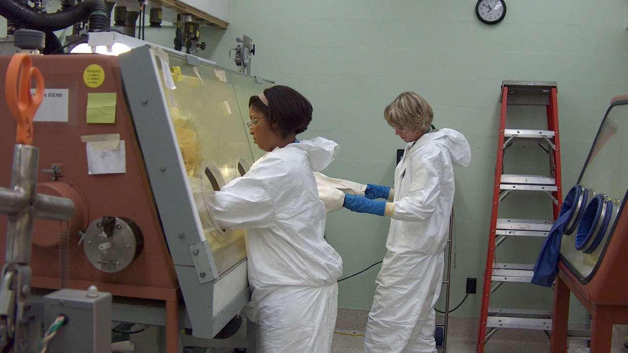 Clarice Phelps works in 2012 to purify the element berkelium as fellow scientist Shelley VanCleve observes at Oak Ridge National Lab in Tennessee.