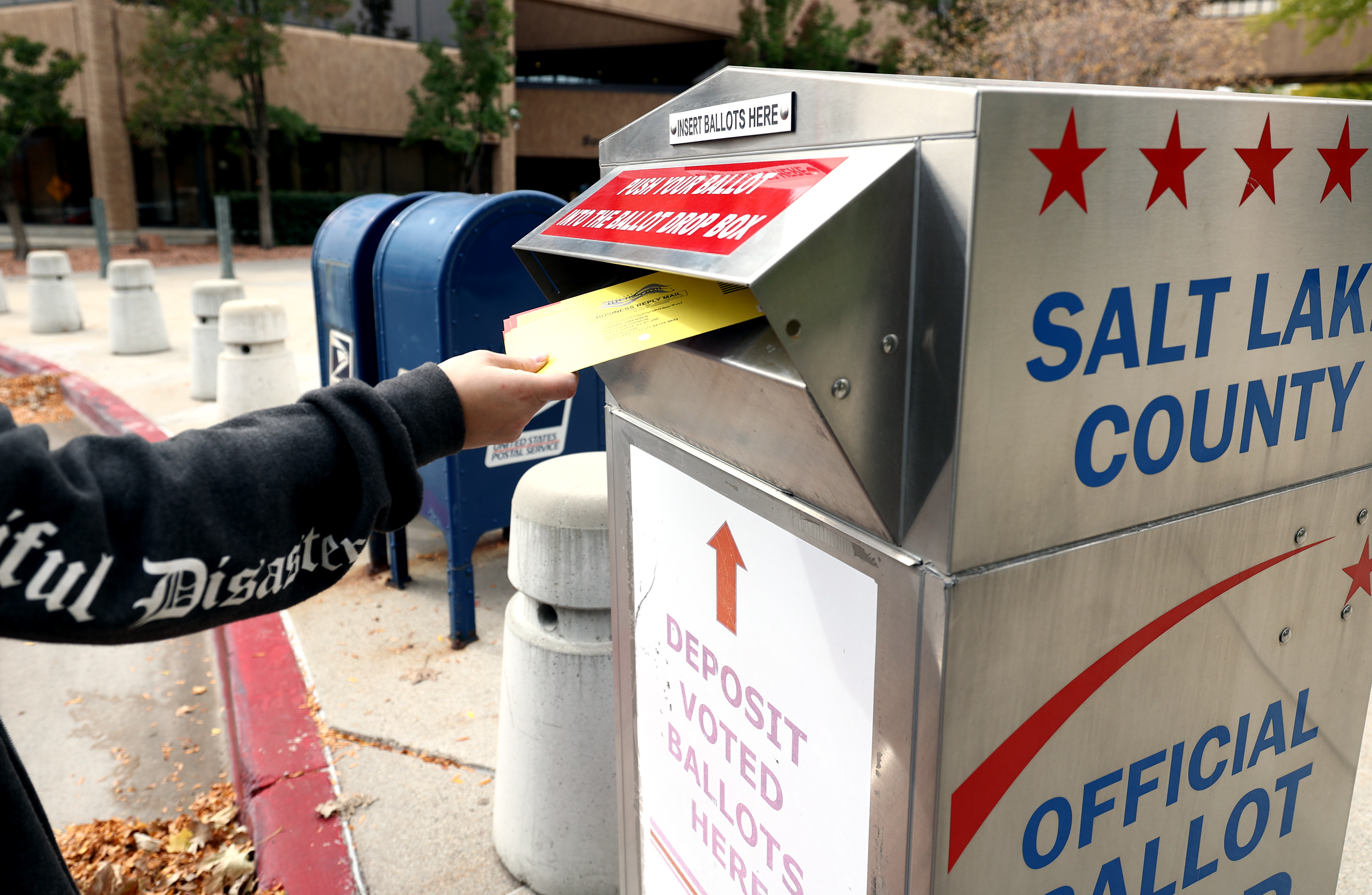 A voter drops a ballot into a box at the Salt Lake County Government Center in Salt Lake City on Oct. 18, 2021. HB347, sponsored by Rep. Michael Petersen, R-North Logan, would make tampering with, removing or destroying a ballot drop box a third-degree felony.