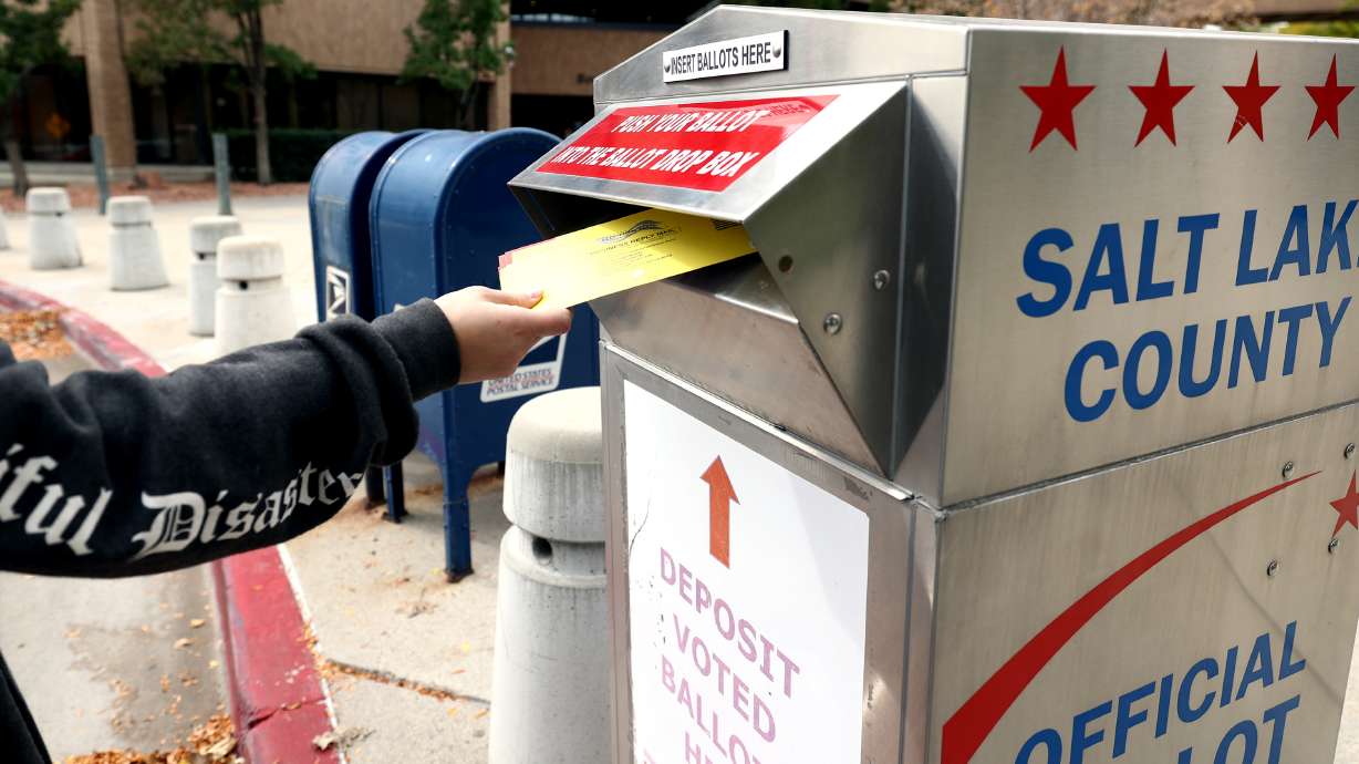 A voter drops a ballot into a box at the Salt Lake County Government Center in Salt Lake City on Oct. 18, 2021. HB347, sponsored by Rep. Michael Petersen, R-North Logan, would make tampering with, removing or destroying a ballot drop box a third-degree felony.