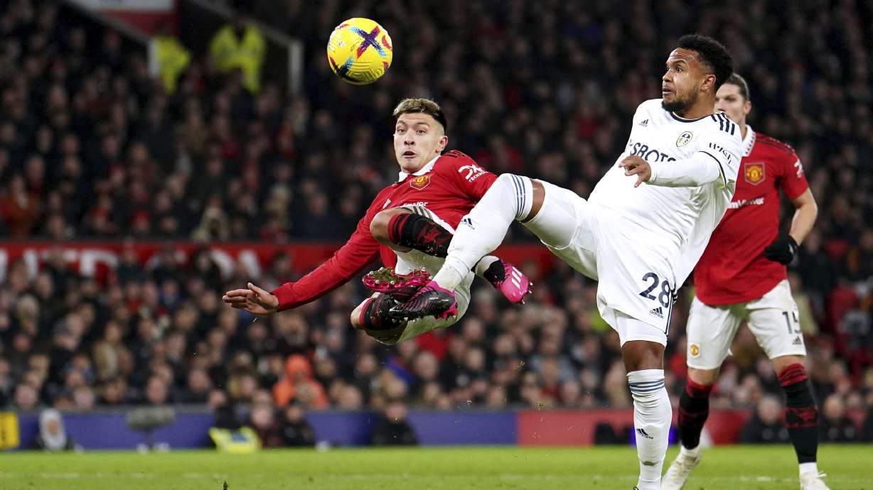 Leeds United's Weston McKennie, right, and Manchester United's Lisandro Martinez battle for the ball during an English Premier League soccer match at Old Trafford in Manchester, England, Wednesday, Feb. 8, 2023.