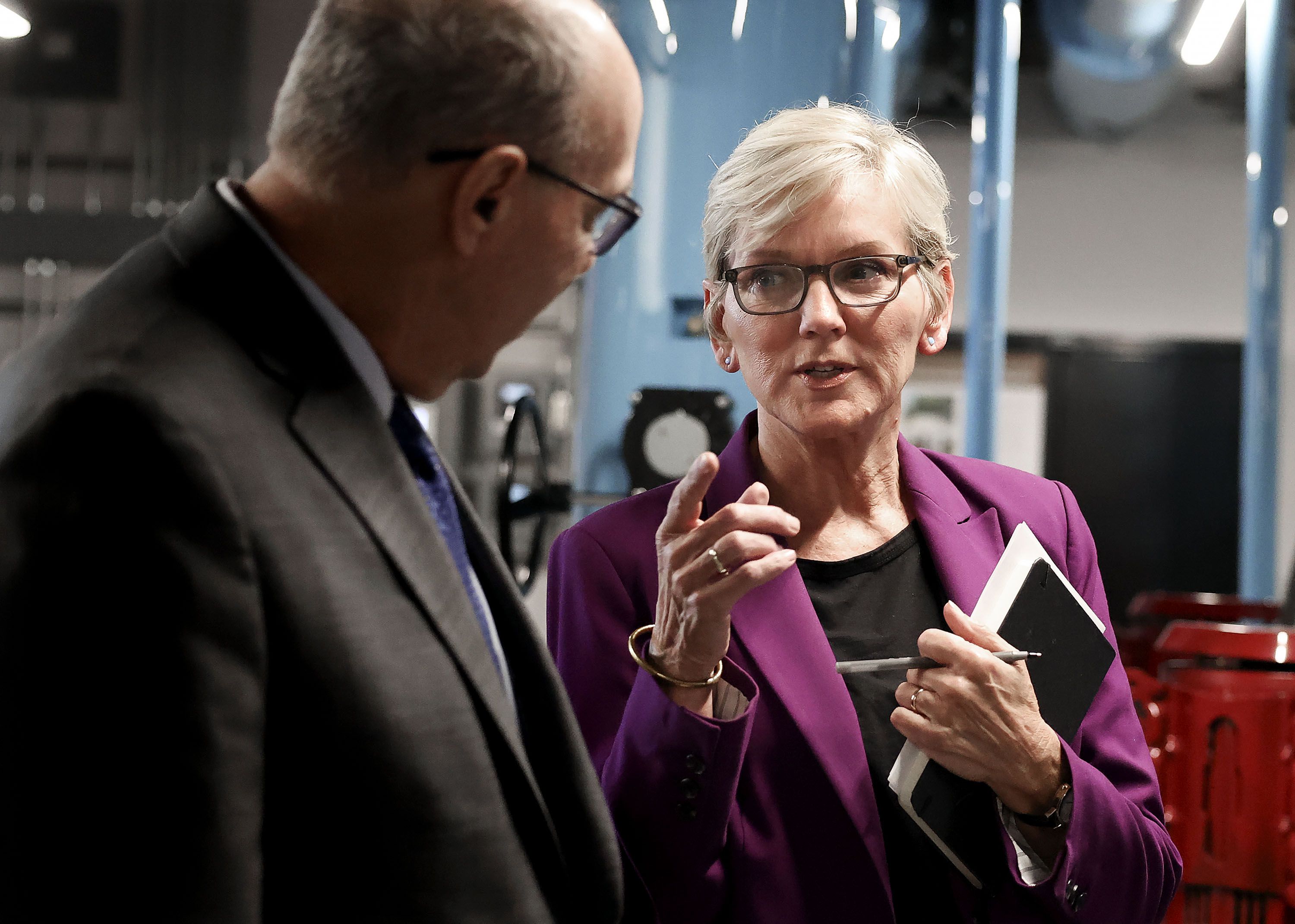 Joseph Moore, managing principal investigator of the Utah FORGE site, speaks with U.S. Energy Secretary Jennifer M. Granholm in the pump room of Gardner Commons at the University of Utah in Salt Lake City on Wednesday.