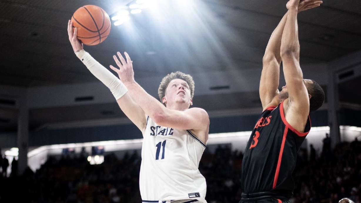 Utah State guard Max Shulga attempts a shot over San Diego State at the Spectrum in Logan, Utah, on Feb. 8, 2023.