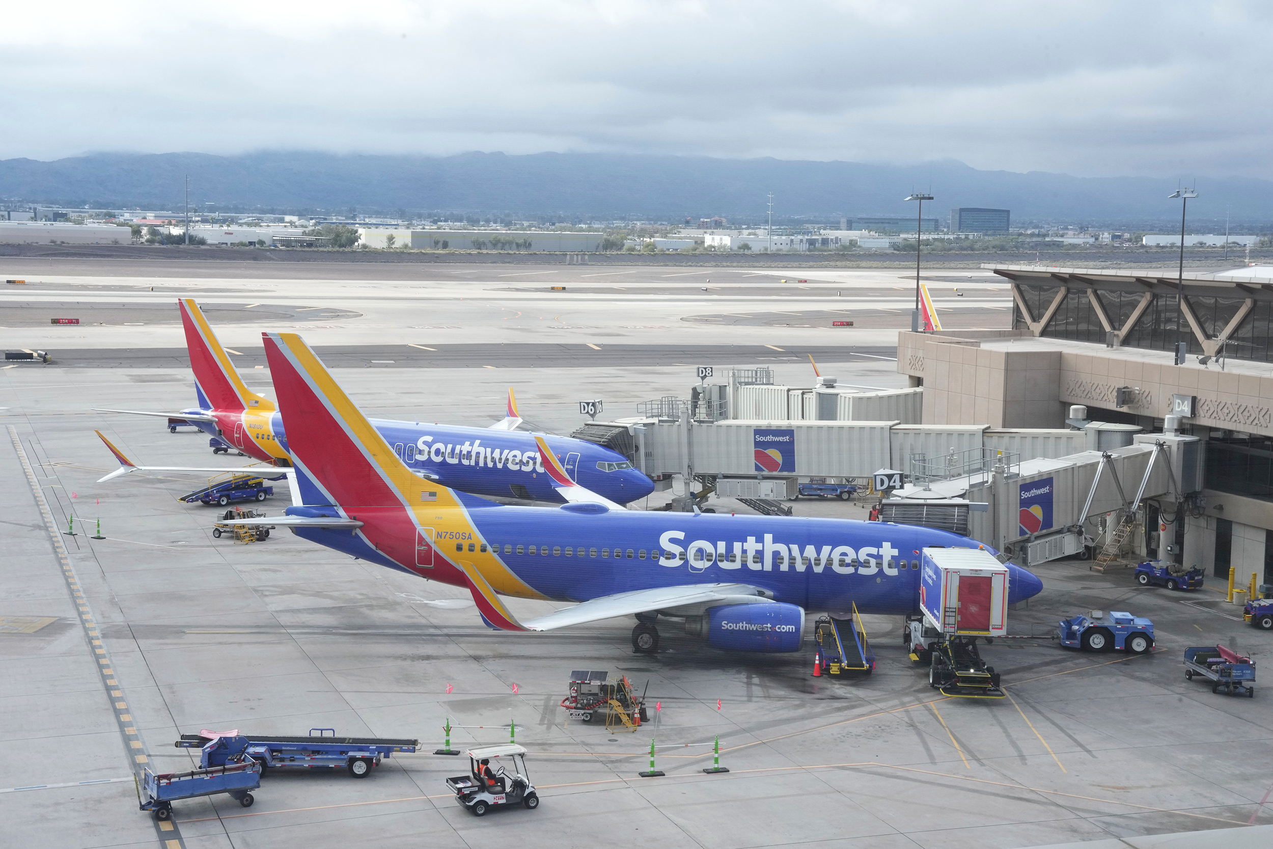 Southwest Airlines planes parked at Gates D4 and D6 in Terminal 4 of the Sky Harbor International Airport, Dec. 30, 2022, in Phoenix. Congress is receiving new evidence Thursday of internal chaos at Southwest Airlines over the Christmas holiday meltdown.