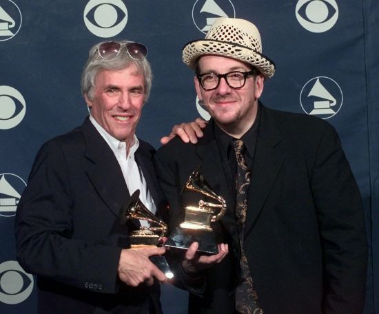 Burt Bacharach, left, and Elvis Costello hold their awards for best pop collaboration with vocals with "I Still Have That Other Girl" during the 41st Annual Grammy Awards in Los Angeles on Feb. 24, 1999. Bacharach died of natural causes Wednesday. He was 94.