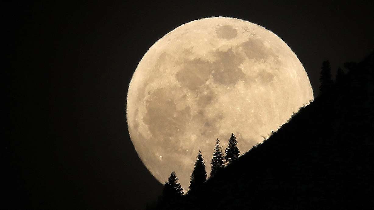 The supermoon rises over Grandeur Peak in Salt Lake City on Jan 30, 2018. Scientists have been searching for ways to curb climate change for decades. While we may not have the whole answer, these astrophysicists have presented an idea that might "buy us time."