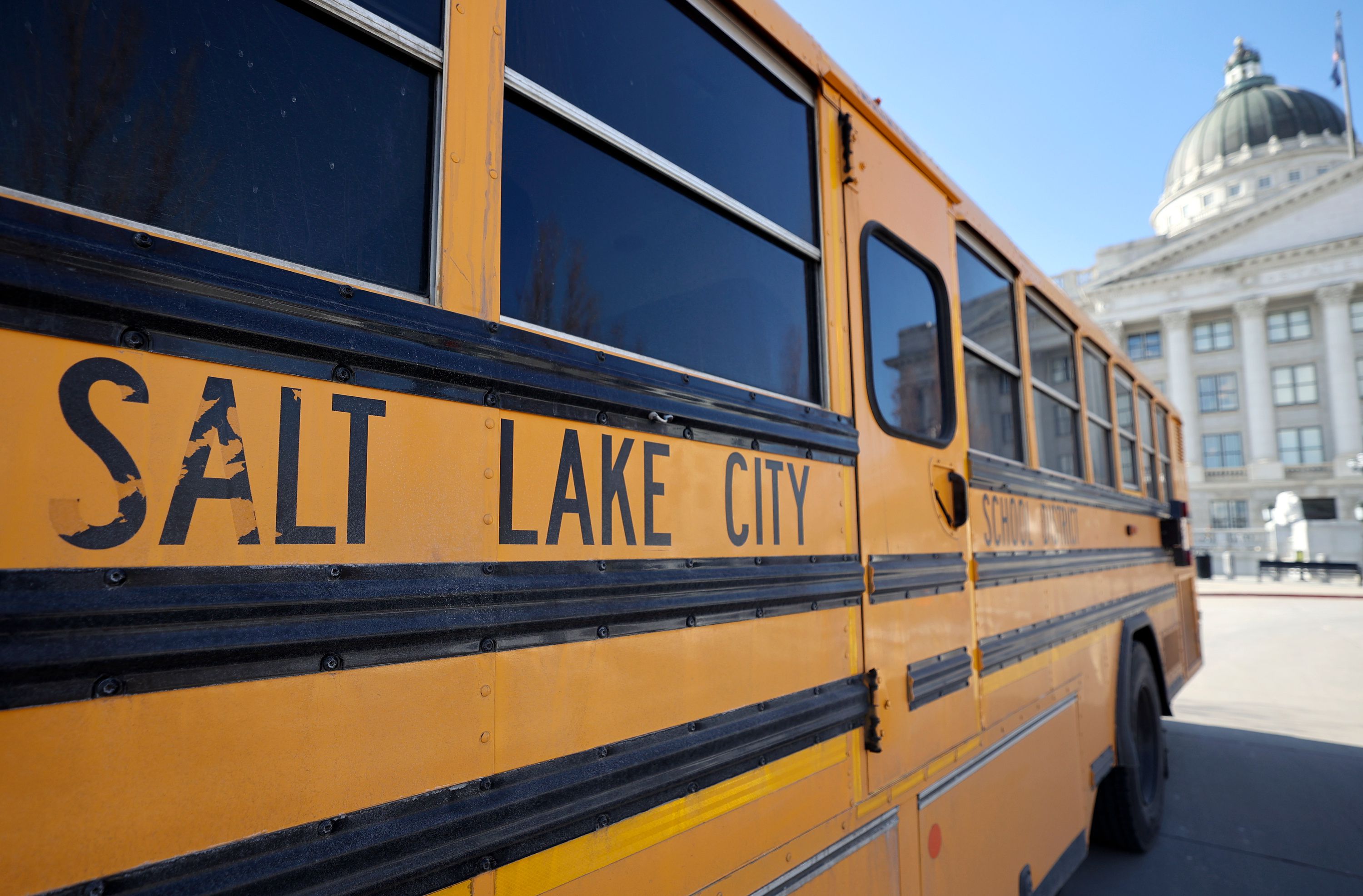 A Salt Lake City School District bus is pictured outside of the Capitol in Salt Lake City, on Tuesday. A legislative proposal calls for local school boards to establish curriculum transparency policies.