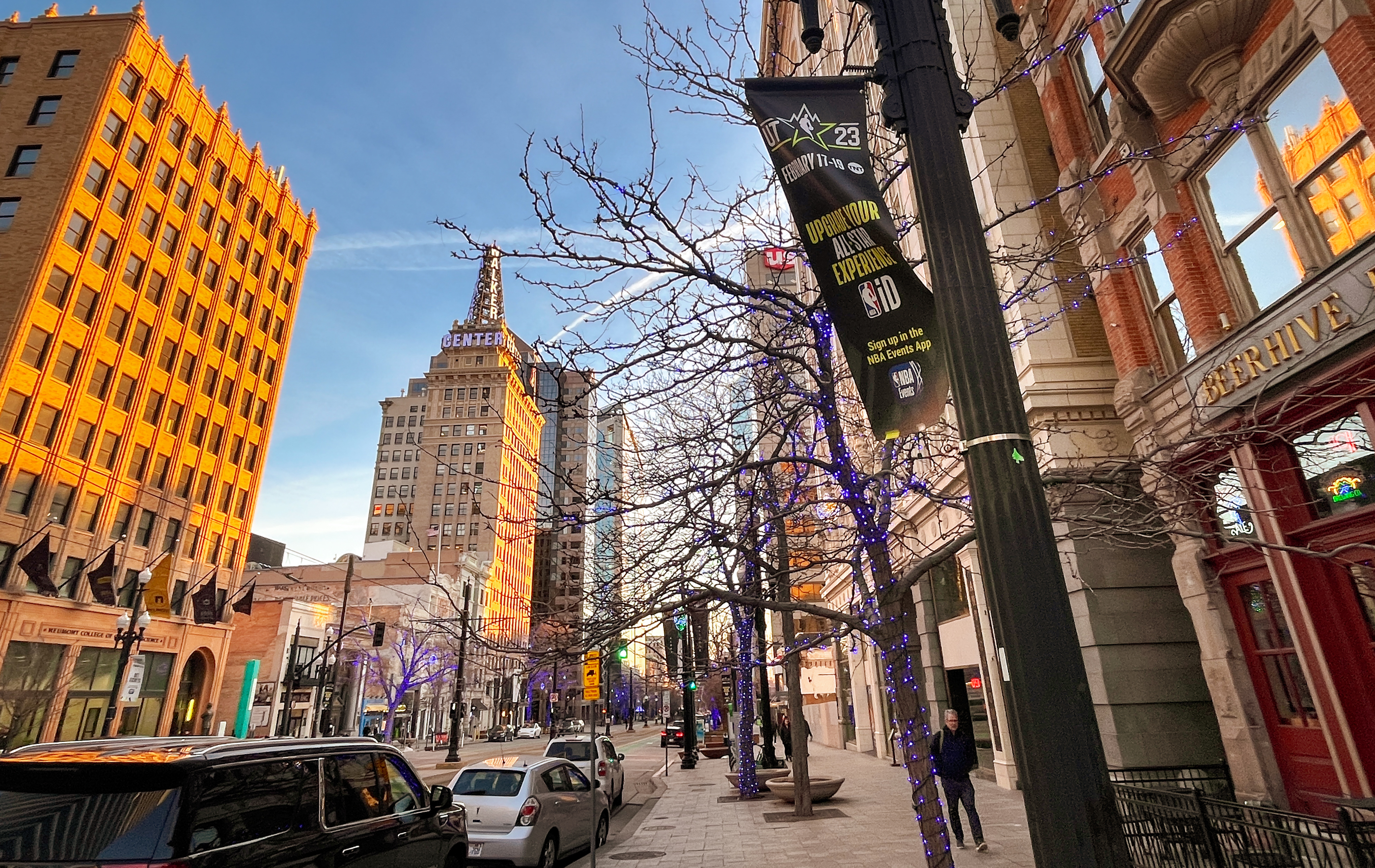 A banner promoting the NBA All-Star Weekend flies on Main Street in Salt Lake City on Thursday evening. The event is projected to bring in more than 100,000 people.