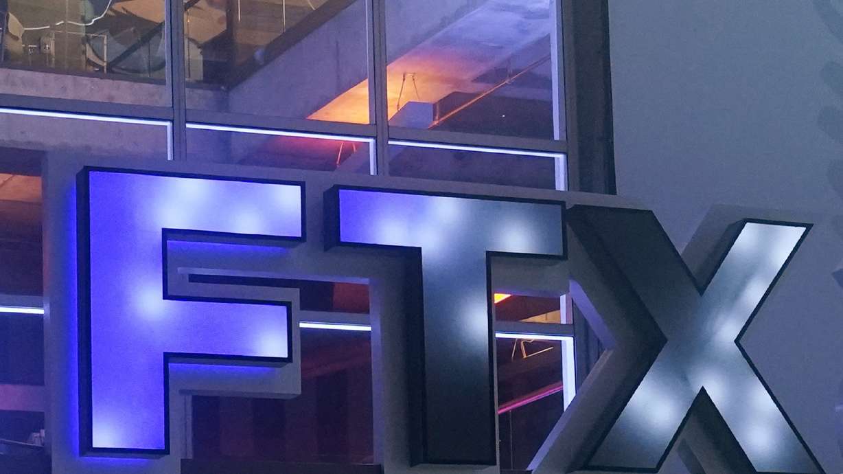 FILE - The logo for cryptocurrency company FTX is displayed on the arena once known as FTX Arena, and now called Miami-Dade Arena, on Nov. 12, 2022, in Miami. Cryptocurrency companies grabbed the spotlight during the 2022 Super Bowl with commercials from a handful of newcomers to advertising's biggest stage. A year later, the industry has been humbled by a massive downturn in crypto prices, as well as the bankruptcy of several well-known companies.