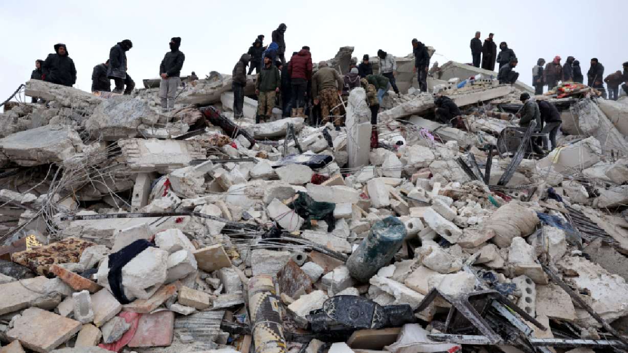 Residents and rescuers search for victims and survivors amid the rubble of collapsed buildings in the village of Besnaya in Syria northwestern Idlib province on the border with Türkiye following earthquakes on Monday.