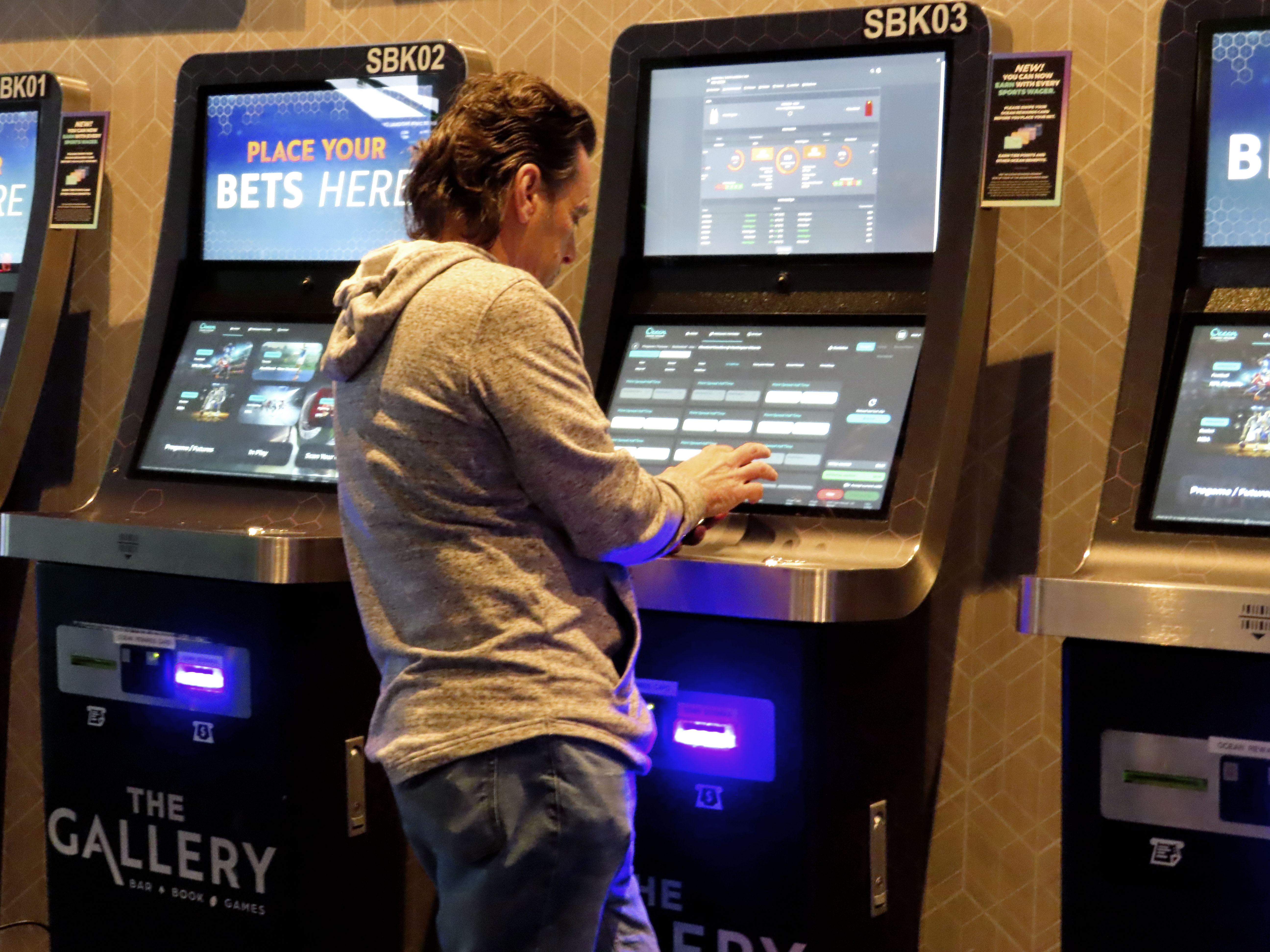 A man checks the odds on a sports betting terminal at the Ocean Casino Resort in Atlantic City, N.J., Monday, Feb. 6, 2023. On Feb. 7, 2023, the gambling industry's national trade group, the American Gaming Association, predicted that over 50 million American adults will bet a total of $16 billion on this year's Super Bowl, including legal bets with sports books, illegal ones with bookies, and casual bets among friends or relatives.