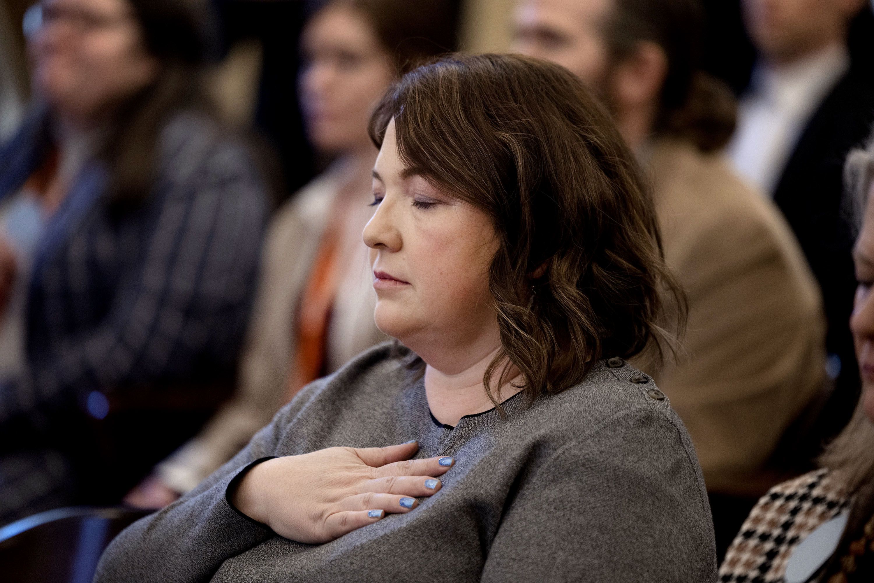 Jamie Hales observes a moment of silence as state and community leaders, survivor moms, maternal mental health providers, advocates and state and federal leaders gather and declare February as Maternal Mental Health Month at the Capitol in Salt Lake City on Thursday.