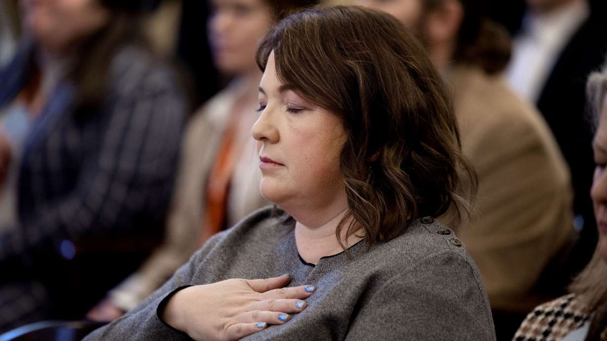 Jamie Hales observes a moment of silence as state and community leaders, survivor moms, maternal mental health providers, advocates and state and federal leaders gather and declare February as Maternal Mental Health Month at the Capitol in Salt Lake City on Thursday.