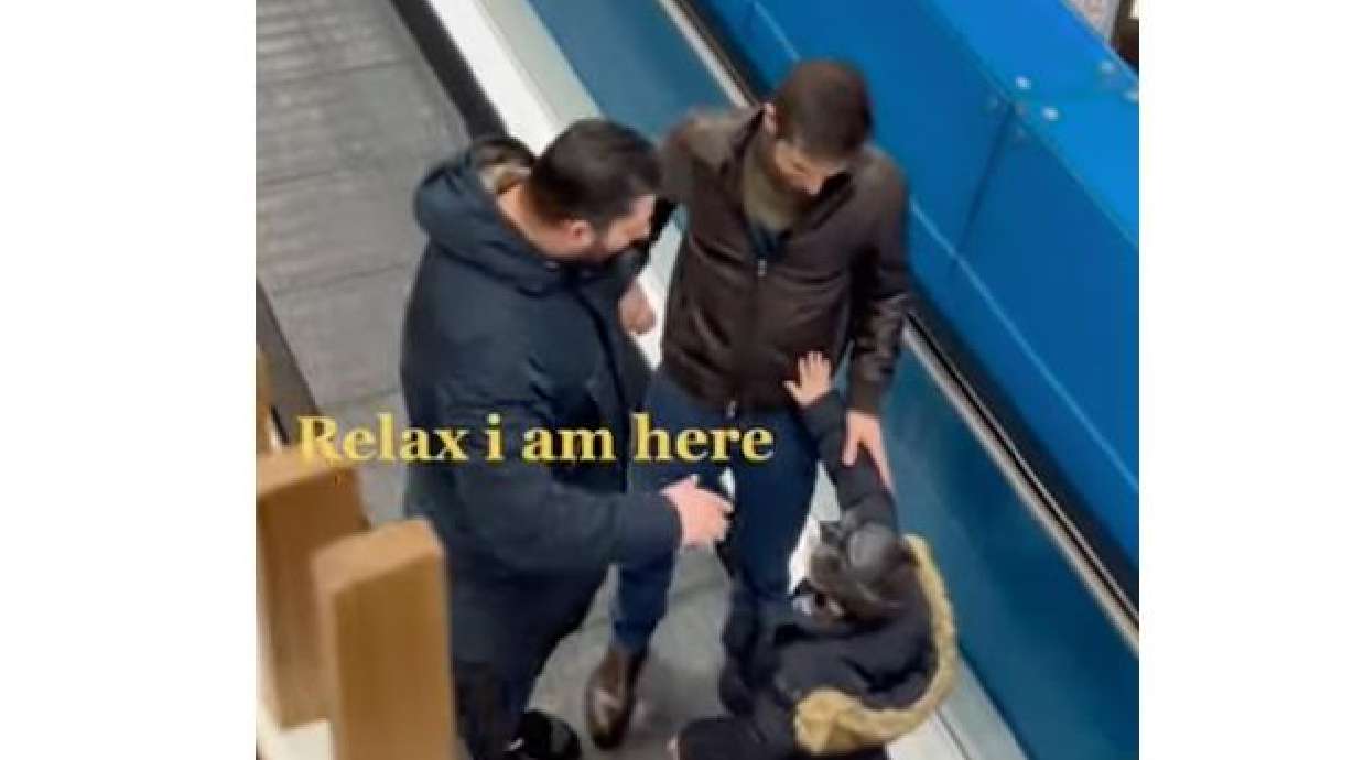 A man and his son help someone safely onto the escalator in this video posted Feb. 7.