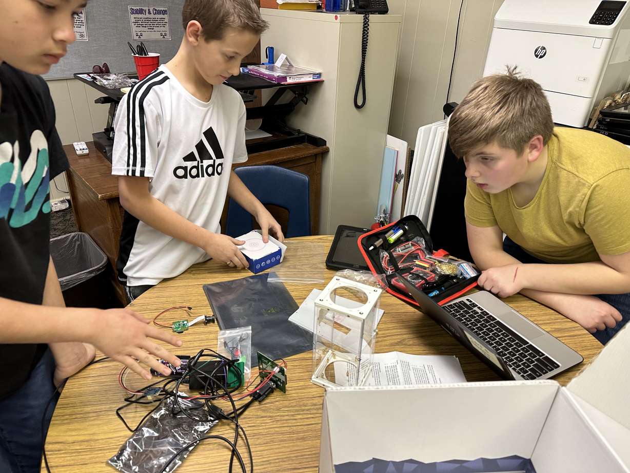 Parkside Elementary School students Thurl Brown, William O'Neill and Tanner Hawkes explain Wednesday how they are going to put an experiment together that will be launched into space on a NASA high-altitude balloon.