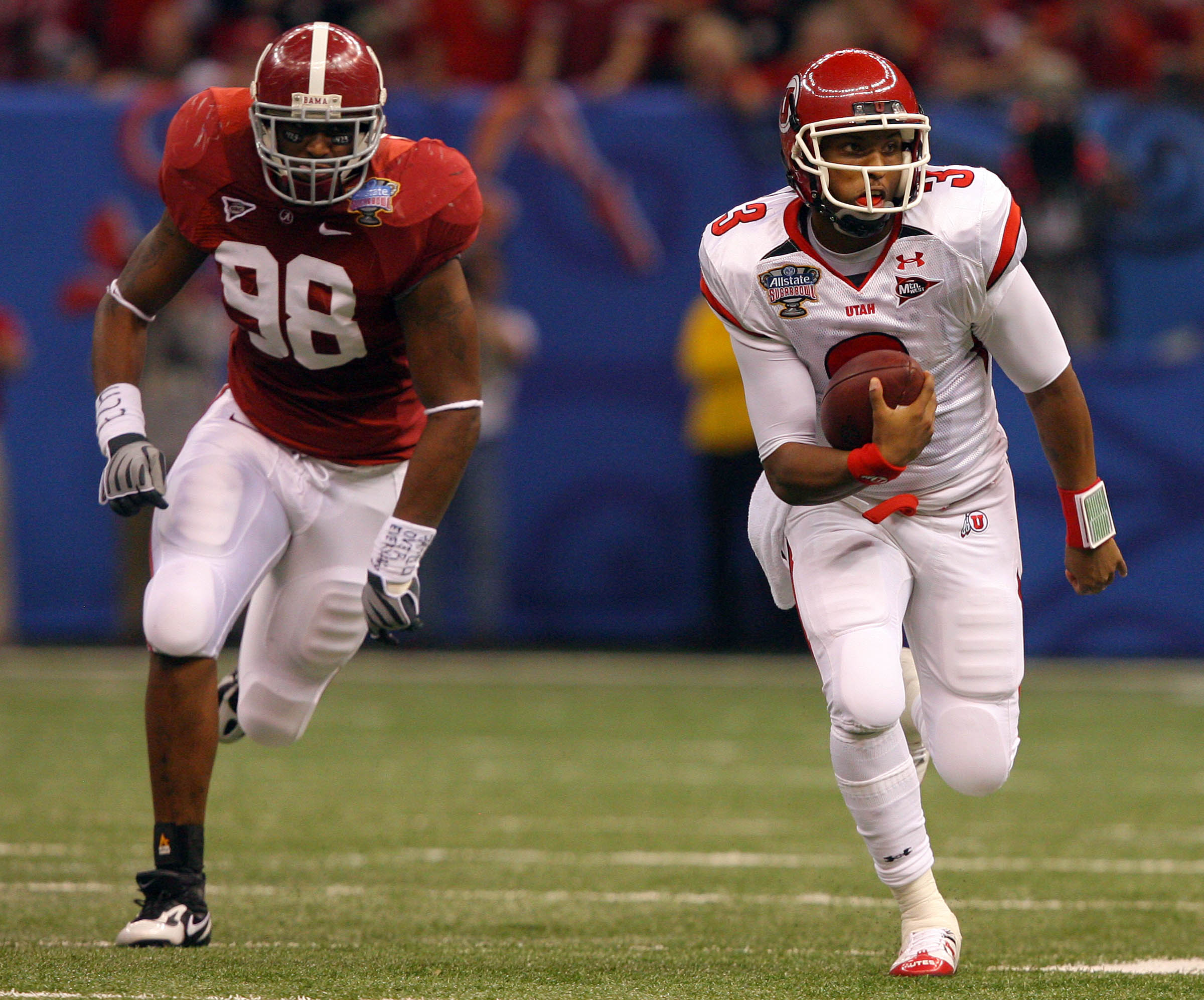 Utah quarterback Brian Johnson (3) runs for a first down with Alabama linebacker Brandon Fanney (98) trailing during the first half of the Sugar Bowl, at the Superdome in New Orleans, Louisiana, Friday, Jan. 2, 2009.