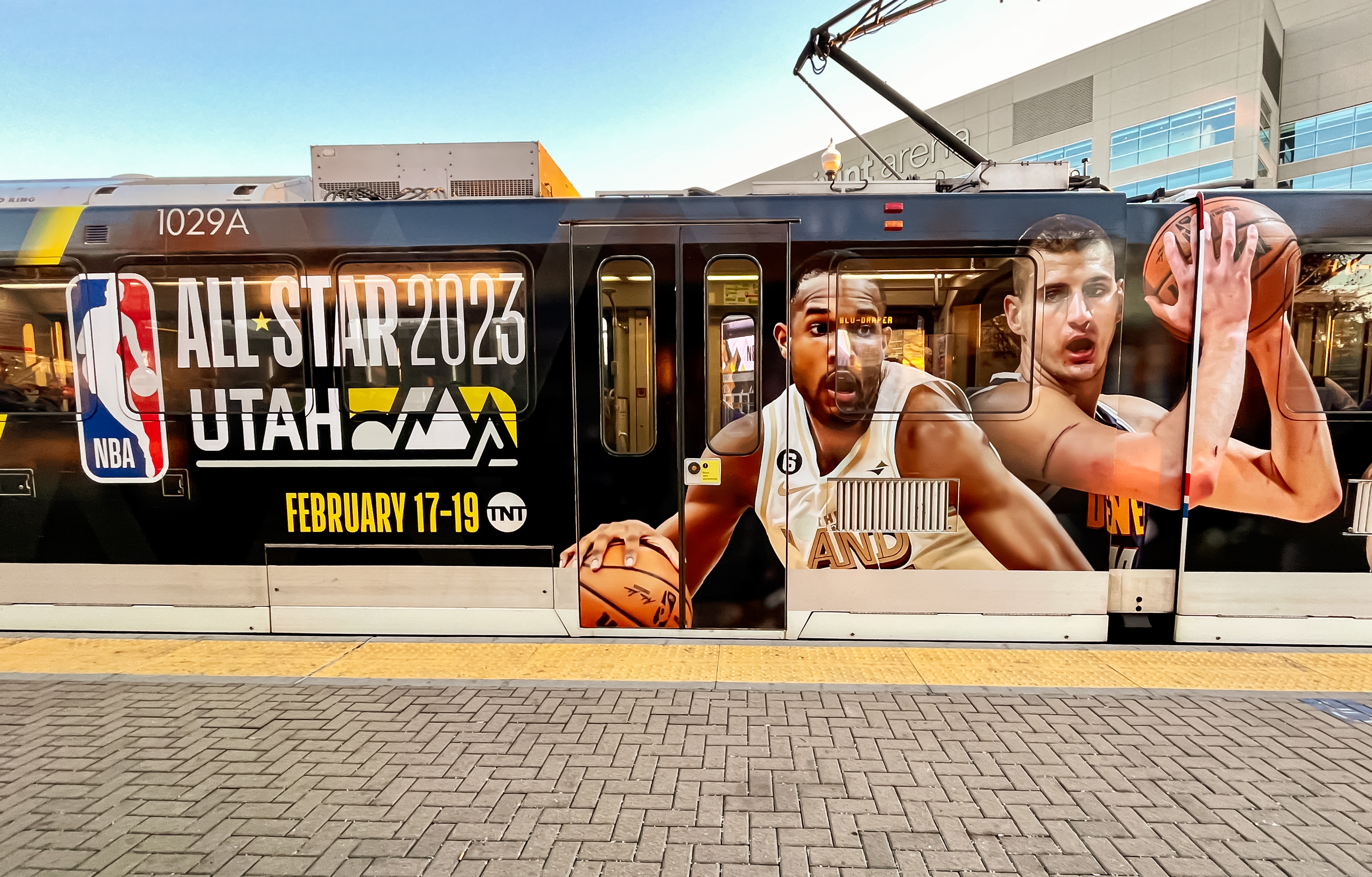 An advertisement for the 2023 NBA All-Star weekend on a TRAX train stopped outside of Vivint Arena on Friday. Utah Transit Authority will be free to ride from Sunday through Feb. 21.