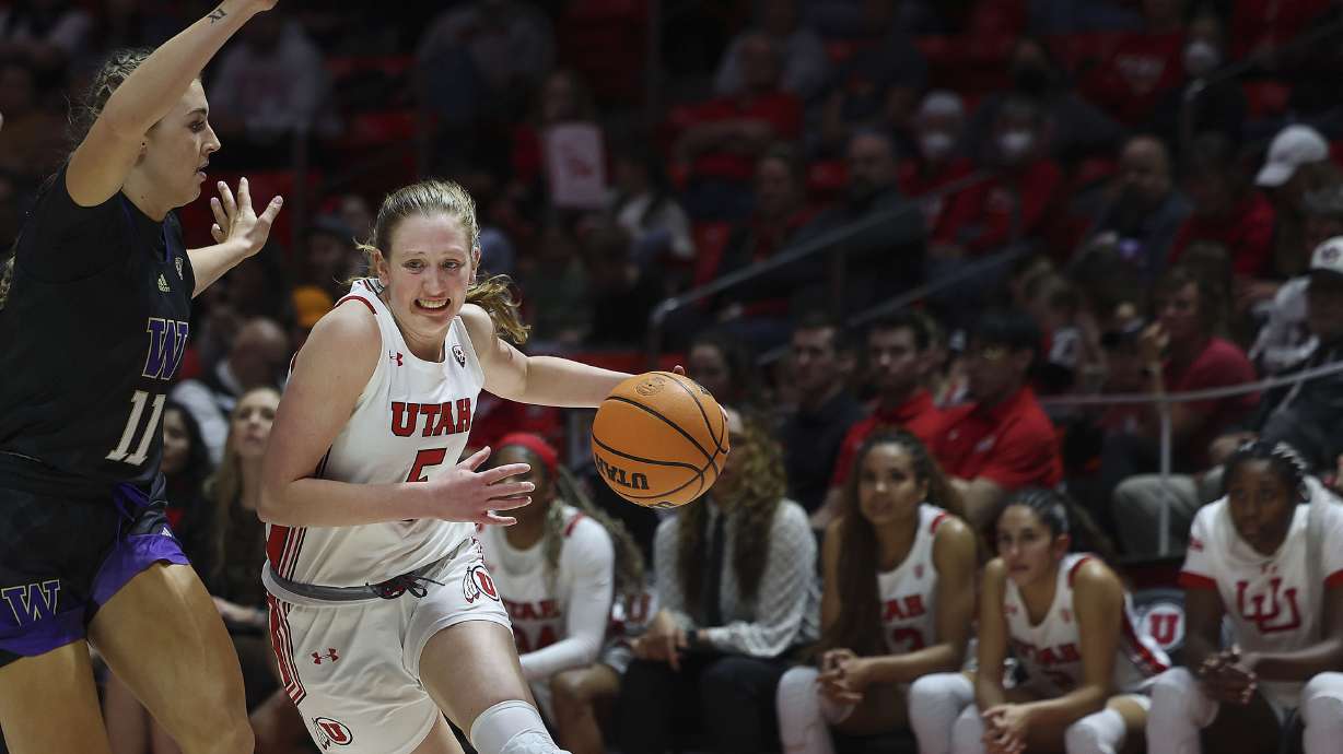 Utah Utes guard Gianna Kneepkens (5) drives against Washington Huskies forward Haley Van Dyke (11) at the Jon M. Huntsman Center in Salt Lake City on Friday, Feb. 10, 2023.
