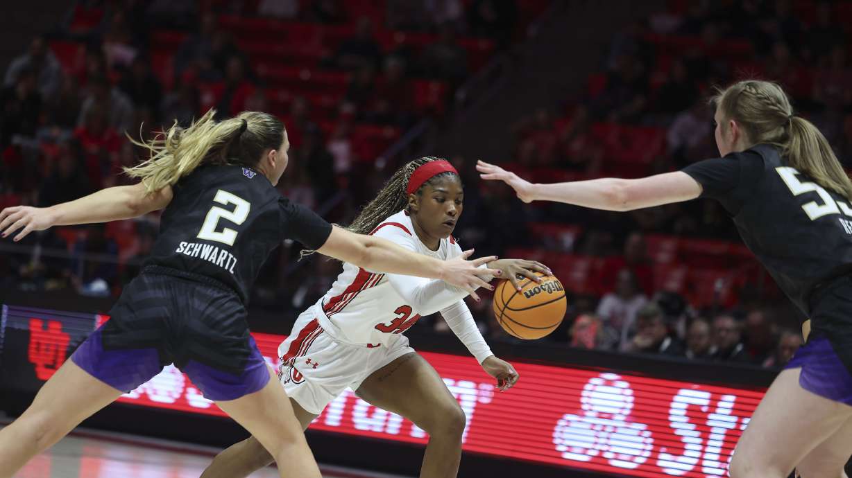 Utah Utes forward Dasia Young (34) dribbles into Washington Huskies forward Lauren Schwartz (2) and Washington Huskies center Darcy Rees (53) at the Jon M. Huntsman Center in Salt Lake City on Friday, Feb. 10, 2023.