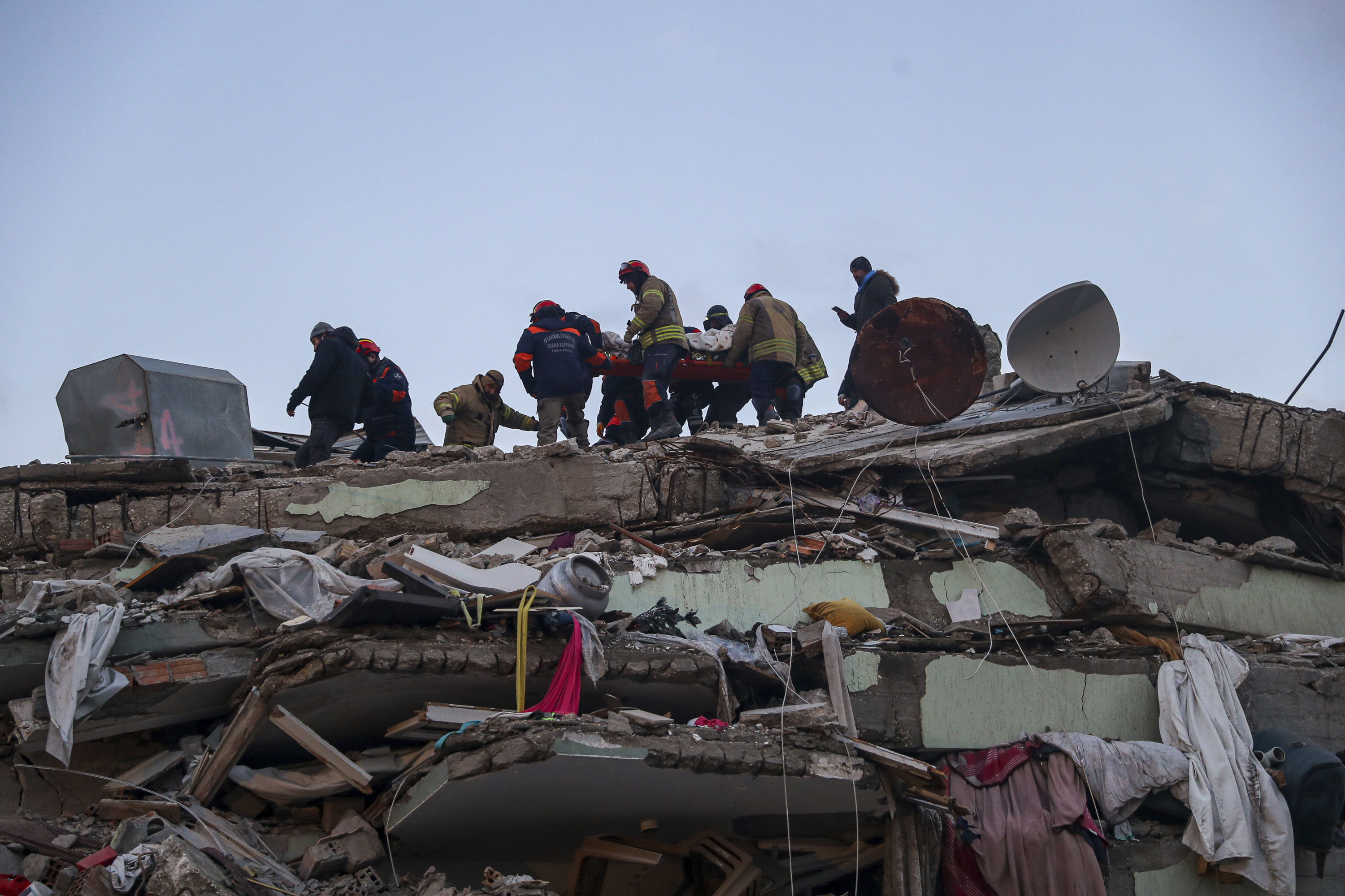 Turkish rescuers work to pull out Ergin Guzeloglan, 36, from a collapsed building five days after an earthquake in Hatay, southern Turkey, early Saturday. 