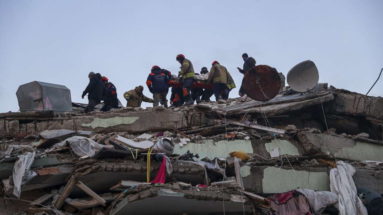 Turkish rescuers work to pull out Ergin Guzeloglan, 36, from a collapsed building five days after an earthquake in Hatay, southern Turkey, early Saturday.